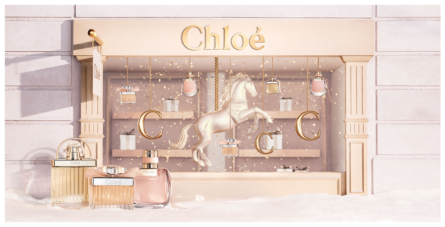 KMA photographer Vincent Gapaillard photographs a Chloe rose gold perfume bottles in front of a pink Chloe store window 