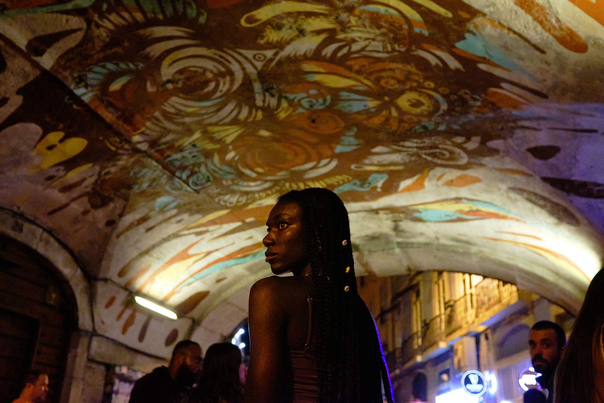 Philippe-Sarfati-reportage-photography-photographer-street-documentary-photojournalism-photojournalist-lisbon-nightlife-covid-curfew-illegal-party-pink-street-graffitti-under-bridge-woman-black-looking-back-afraid
