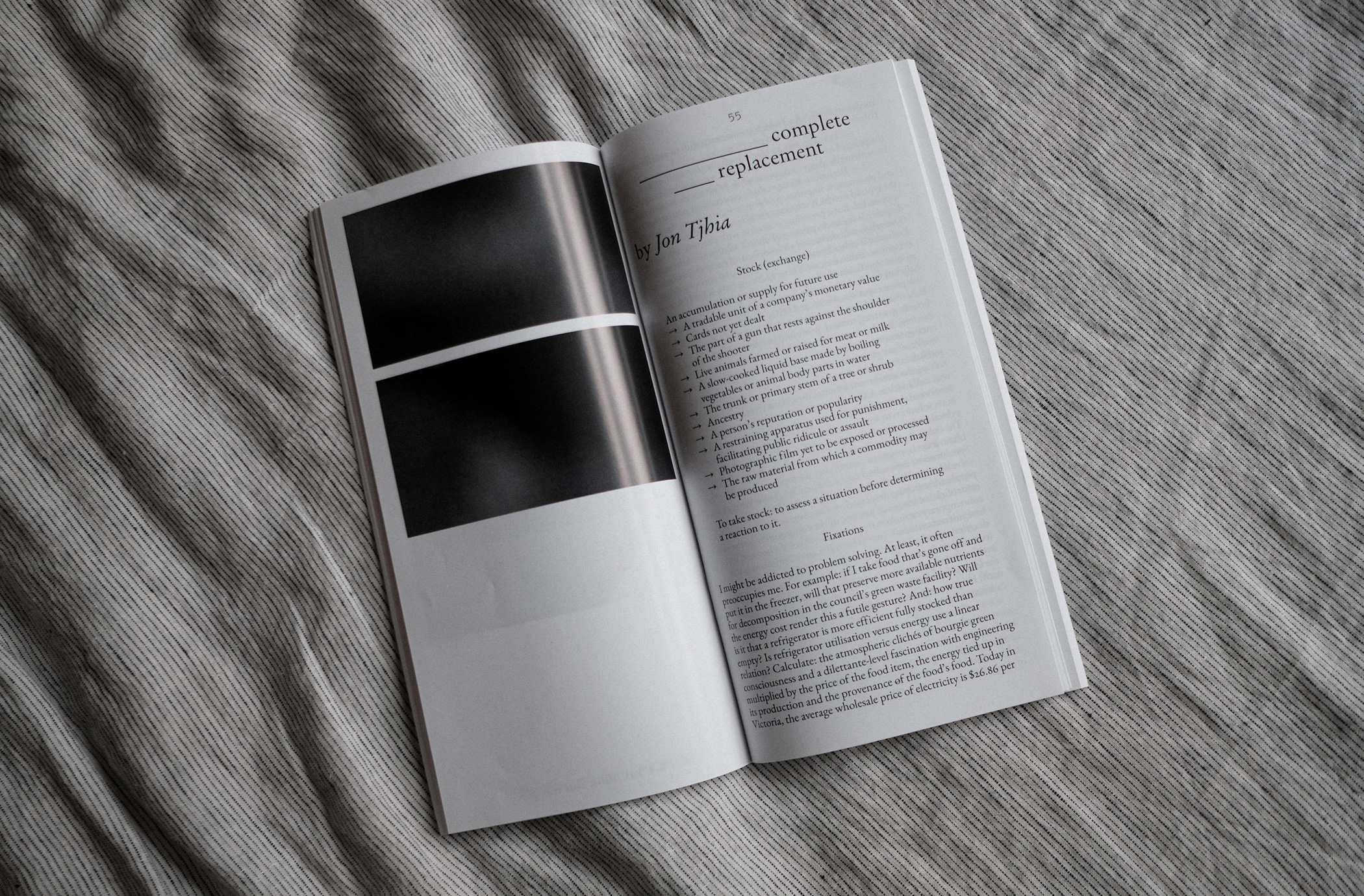 A photograph of a magazine – Un Magazine – opened to the page of the essay mentioned below, laid out on a bed spread