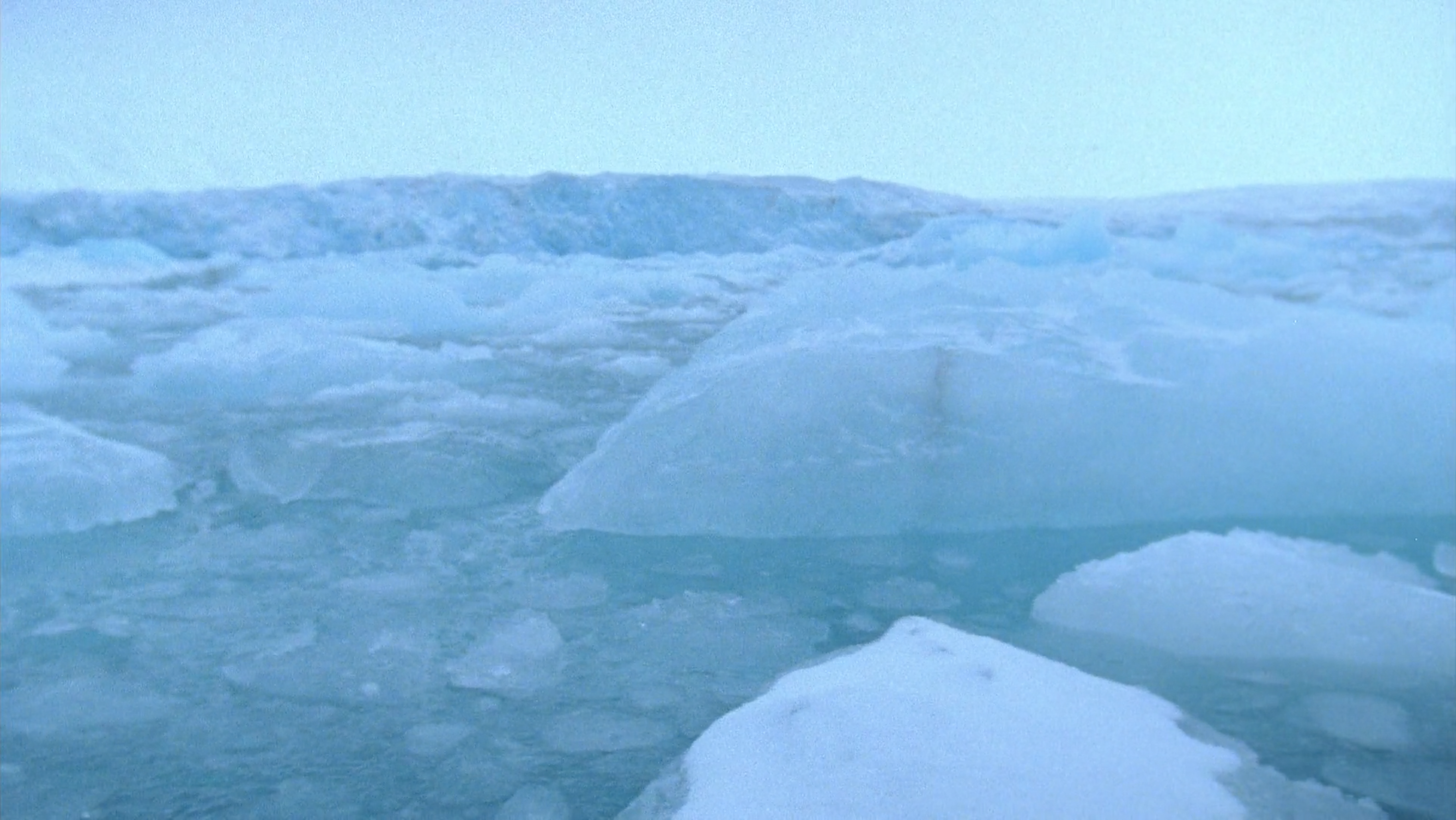 Never Happened Again, Glaciers 2, 2012. Single channel video captured with an Aaton Minima 16mm film camera at Monacobreen, Svalbard Archipelago in the High Arctic. Duration: 8 minutes, 48 seconds. Still frame.