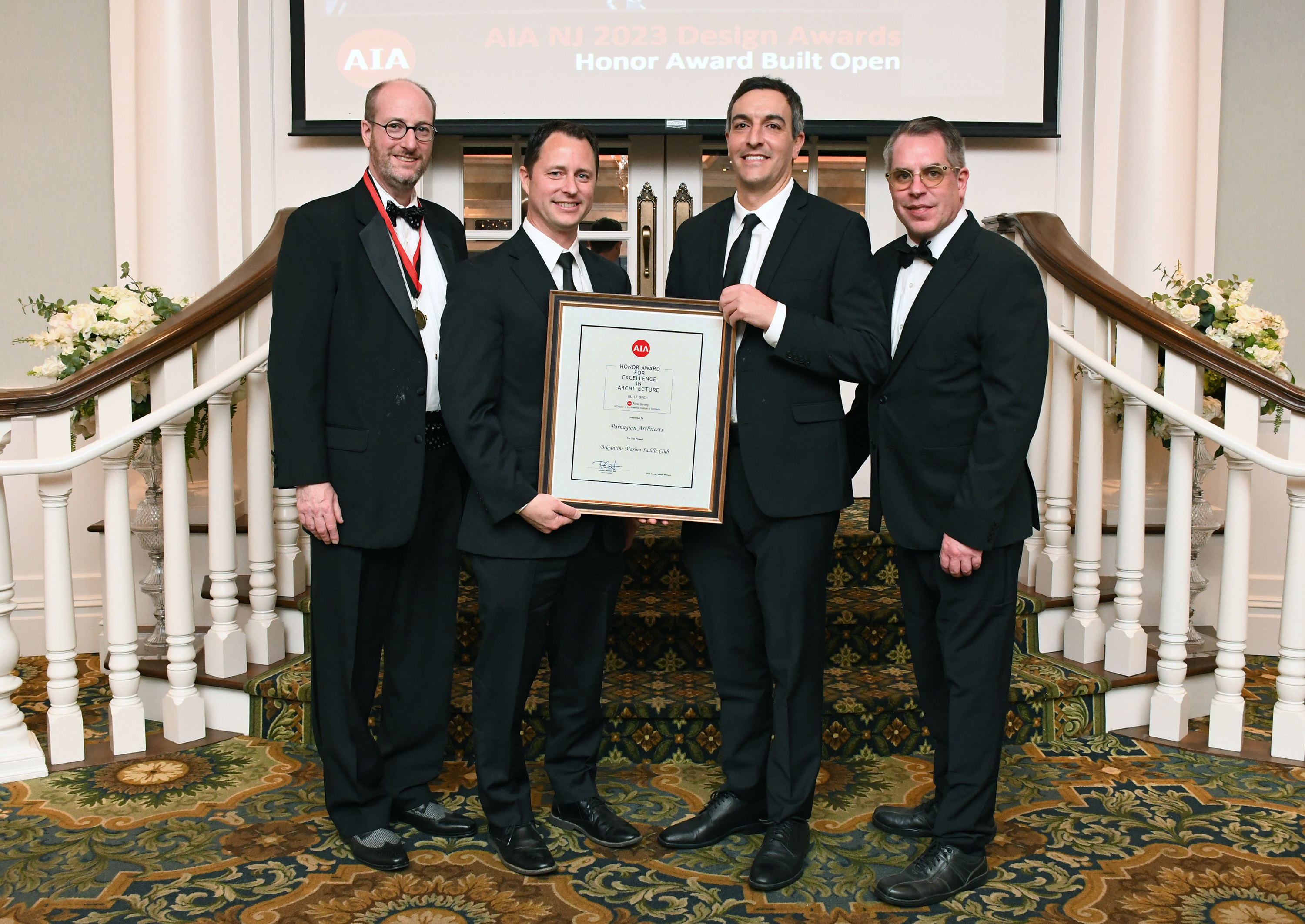 Team members accepting the AIA New Jersey 2024 Honor Award for the Brigantine Marina and Paddle Club project at the Design Awards Gala.