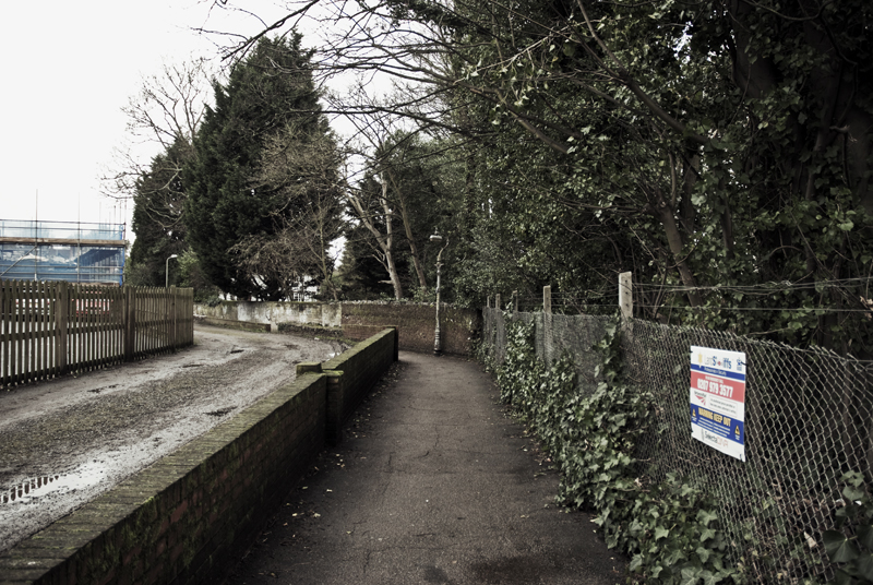 The lanes are so quiet, yet everything is heard there. Senses are heightened to their extremities. In these moments all sensation becomes seamless; no good or bad, just whole. The black bags are still by the railway and the paths of this journey are always there. Late at night he and his friend see the figure and their bags here, sometimes. Sitting on the old adjacent wall, still standing just, halved. This is forever a shadow and continually a journey.