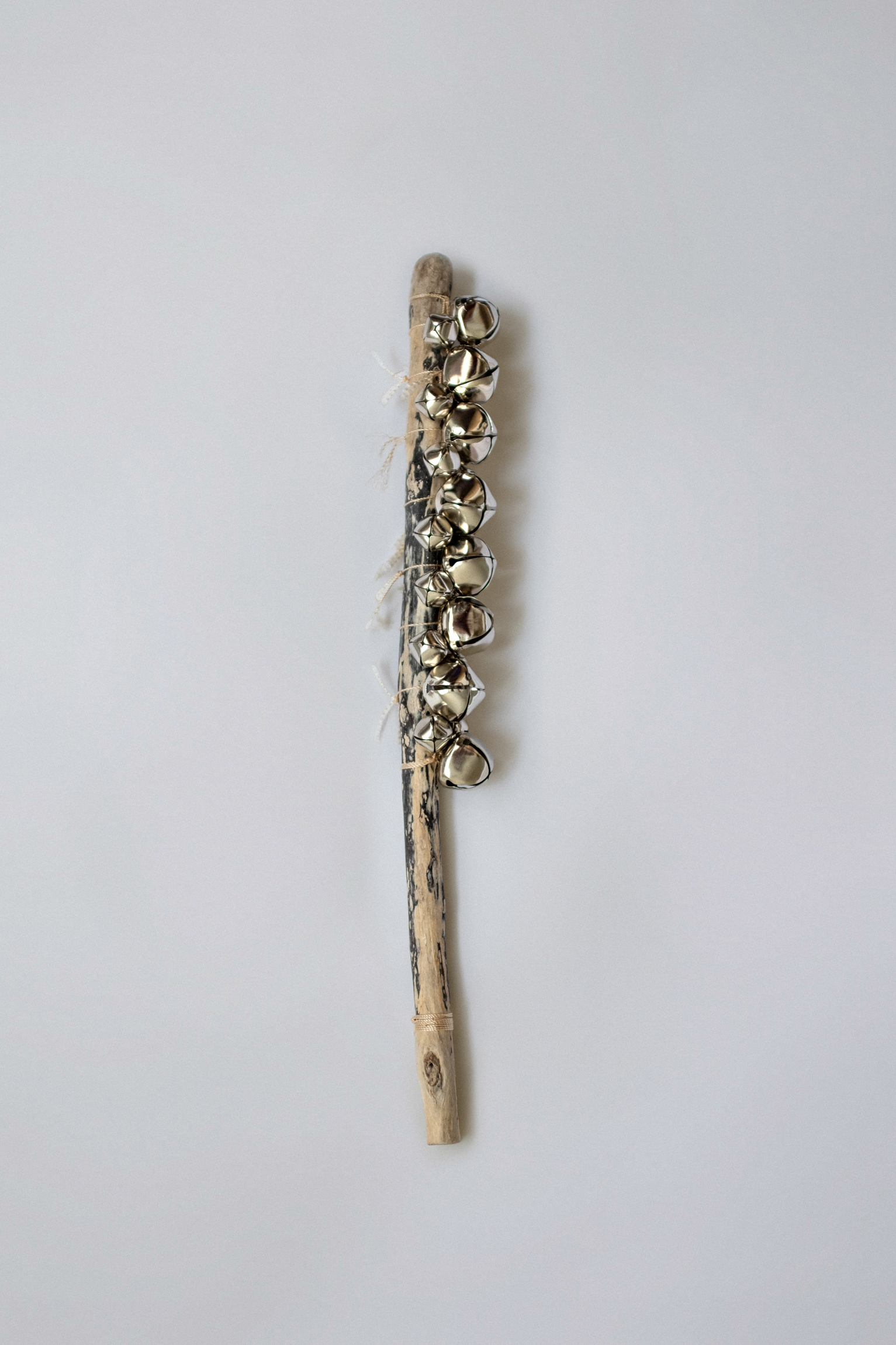 Hand Axe "Transformation", 2025, seaside stick, bells, thread, 44х5 cm
