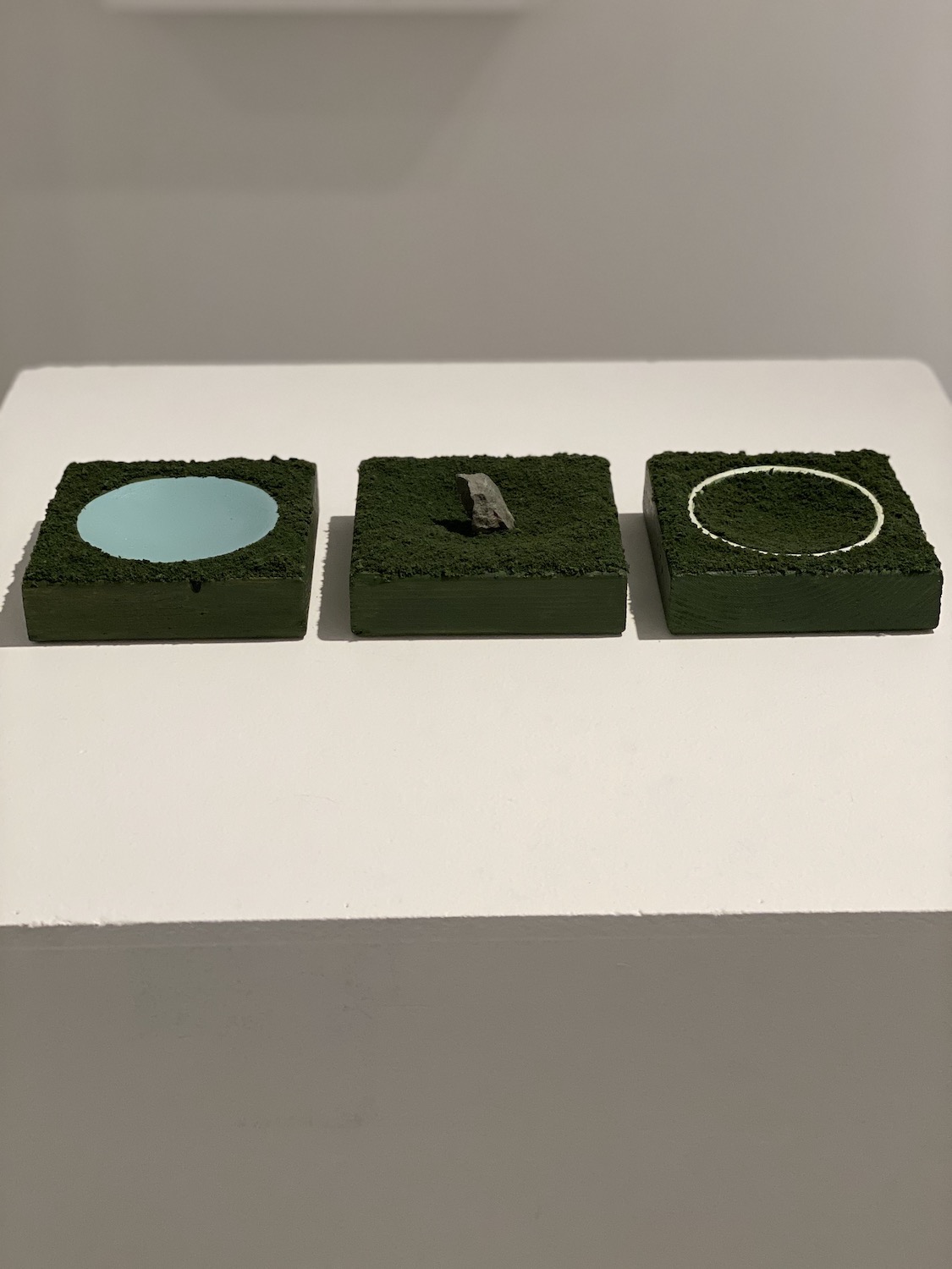 Emily Pettigrew, Earthworks Triptych: Chalk Circle, Standing Stone, Ceremonial Pool, wood, acrylic, architectural model foliage, Irish rock, varying dimensions, 2019, $475