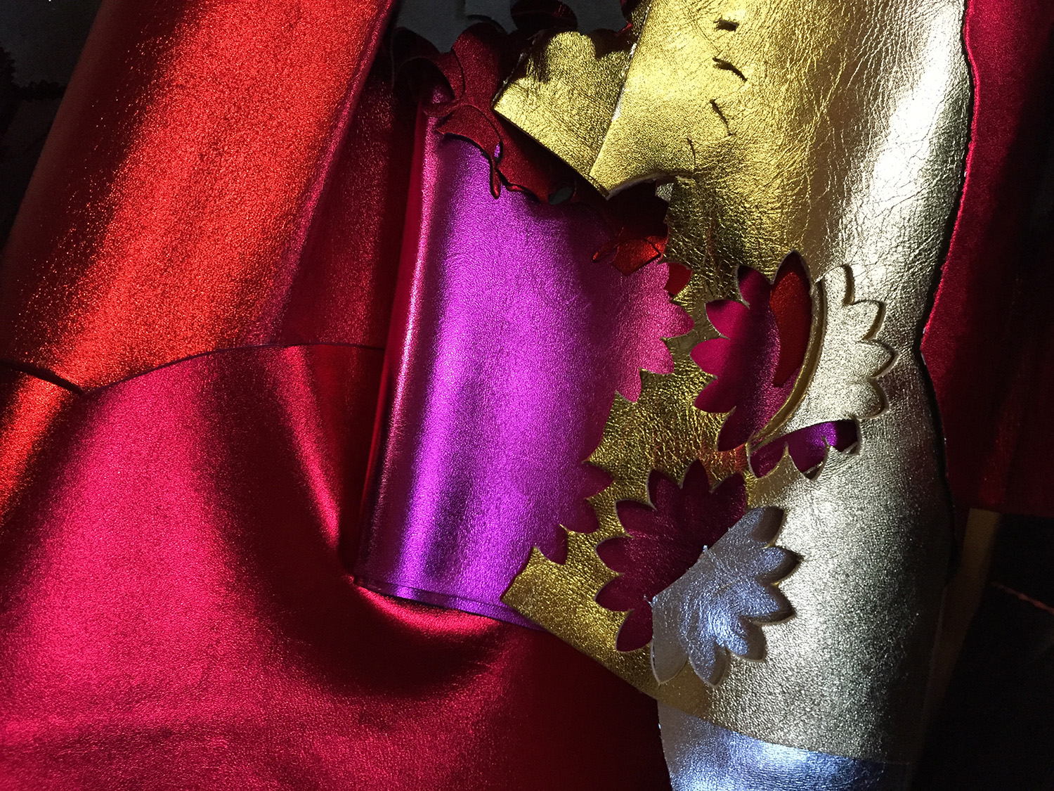 KMA photographer Isabelle Bonjean takes a close up photo of shiny gold and pink fabric