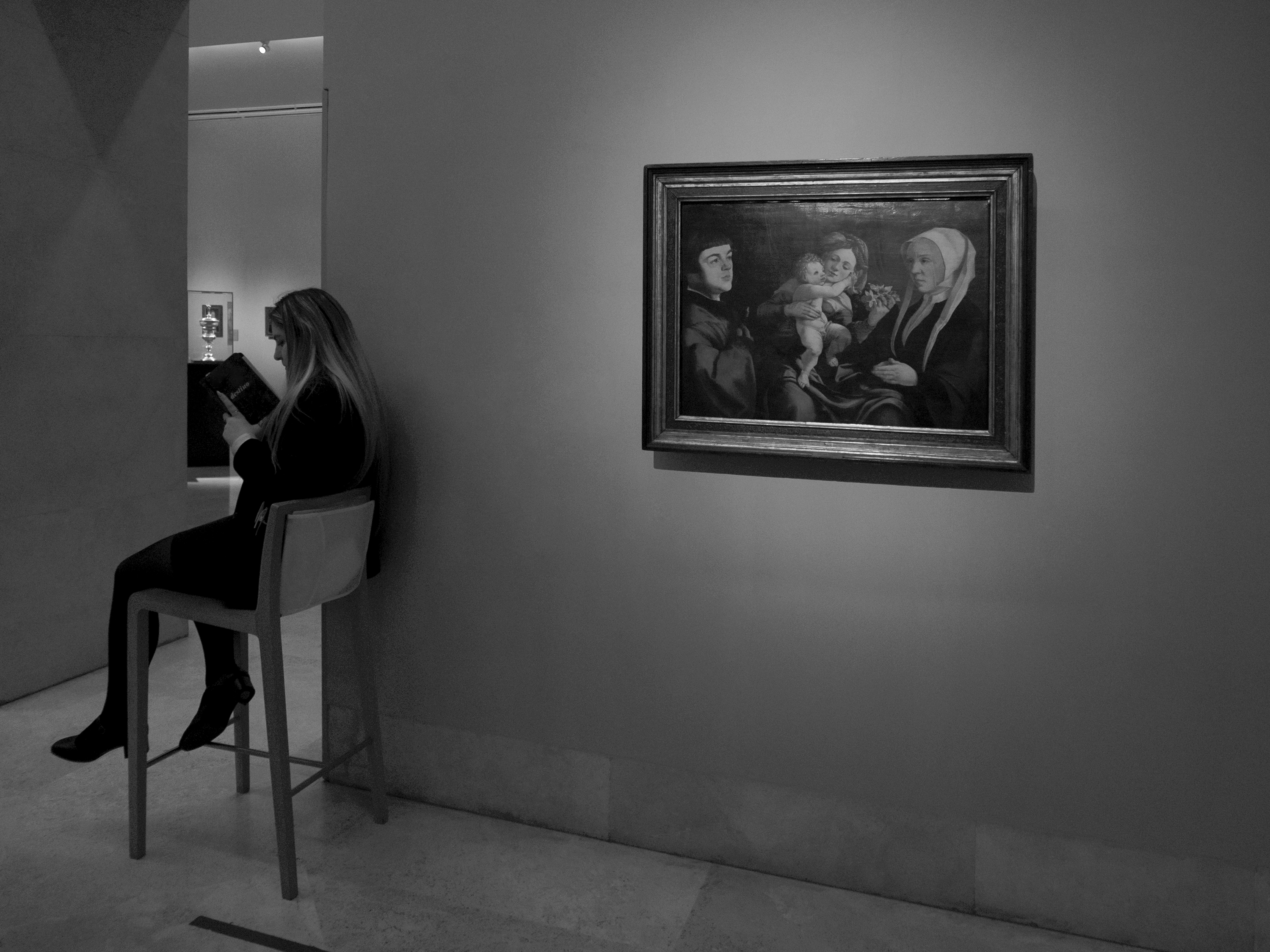 Woman reading at workMadrid, Spain, 2025photography, bw, single