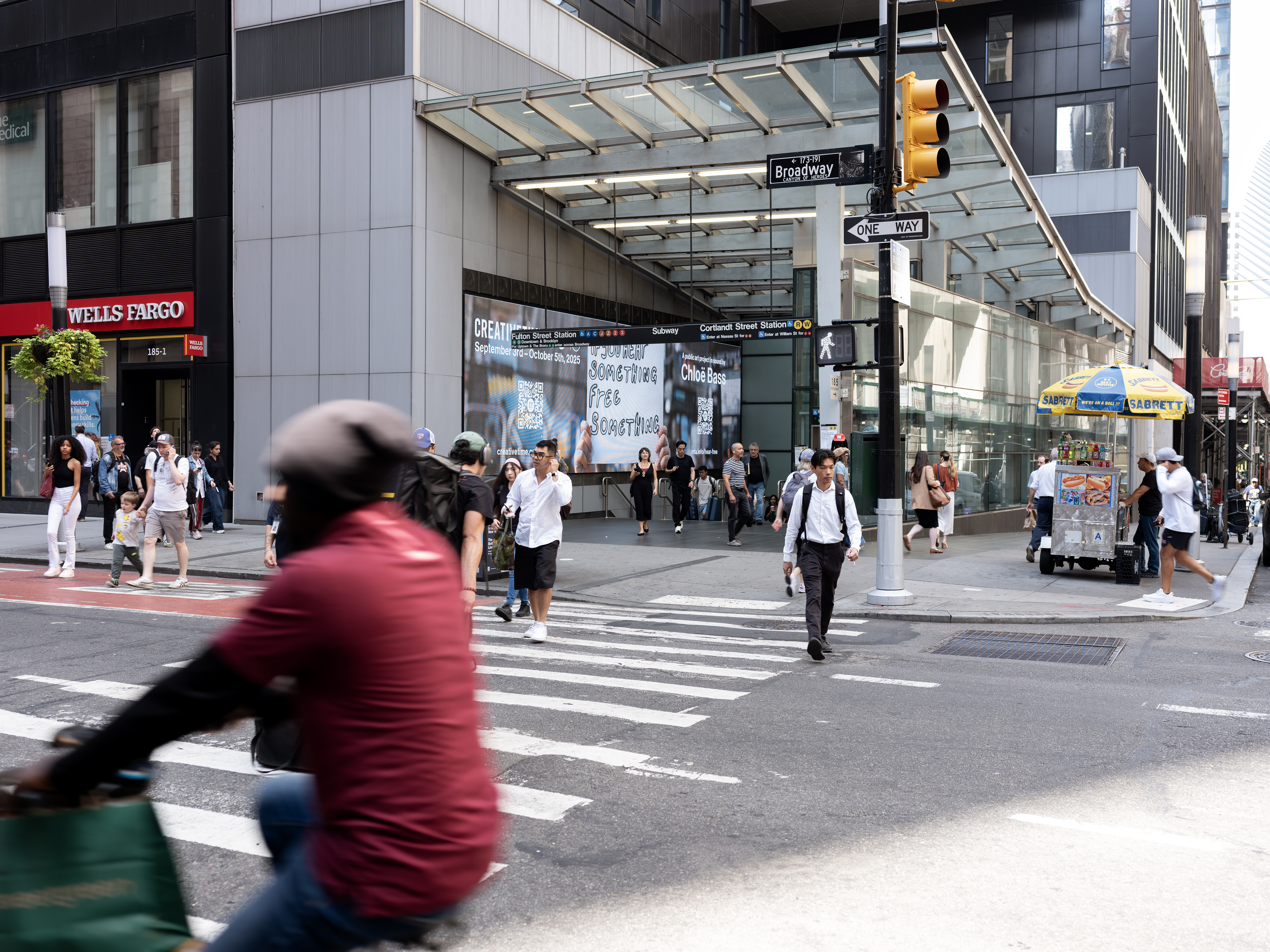 Campaign displayed on a jumbo screen at the exterior entrance to the Fulton Transit hub