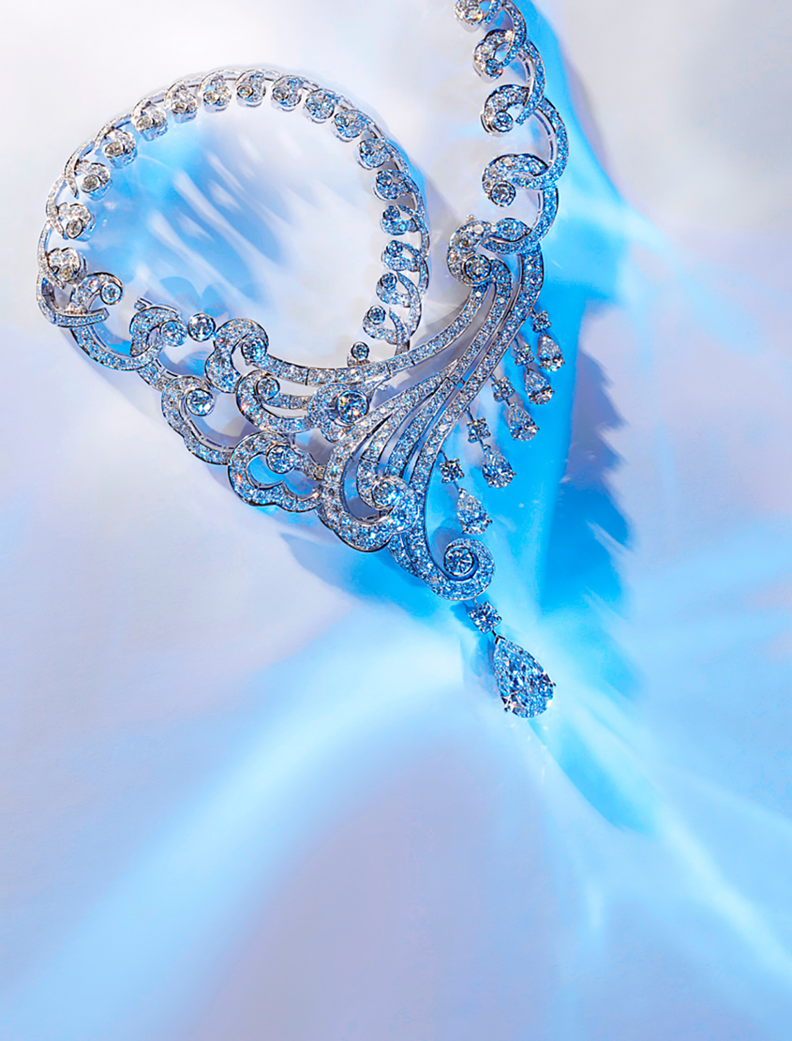 KMA photographer Isabelle Bonjean shoots photograph of diamond necklace against blue and white background for Citizen K