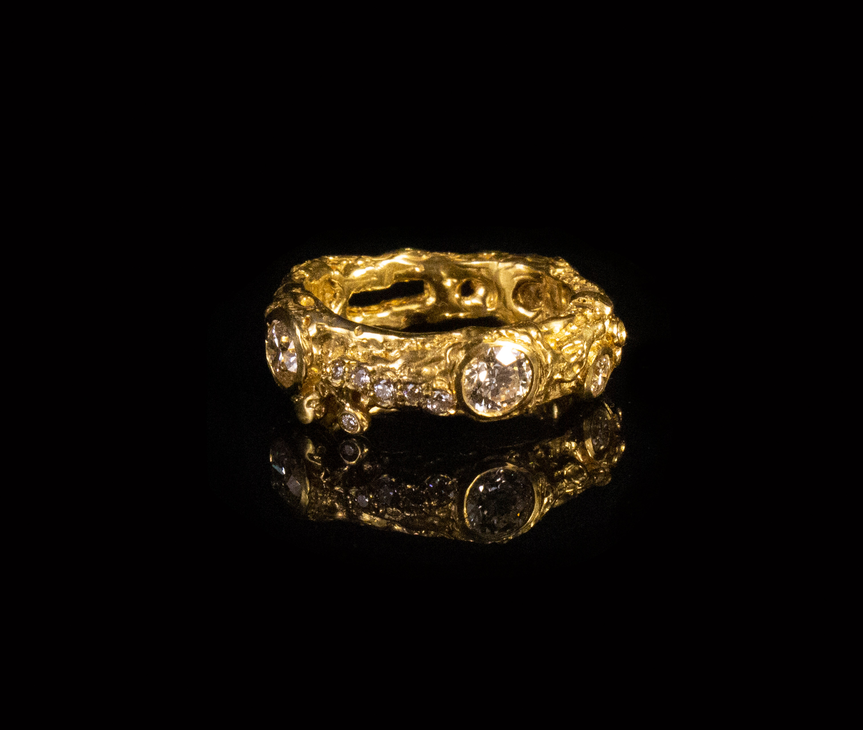 UNIQUE. 22CT RECYCLED GOLD MELTED AROUND 29 FAIRTRADE DIAMONDS, 0.99CTS.