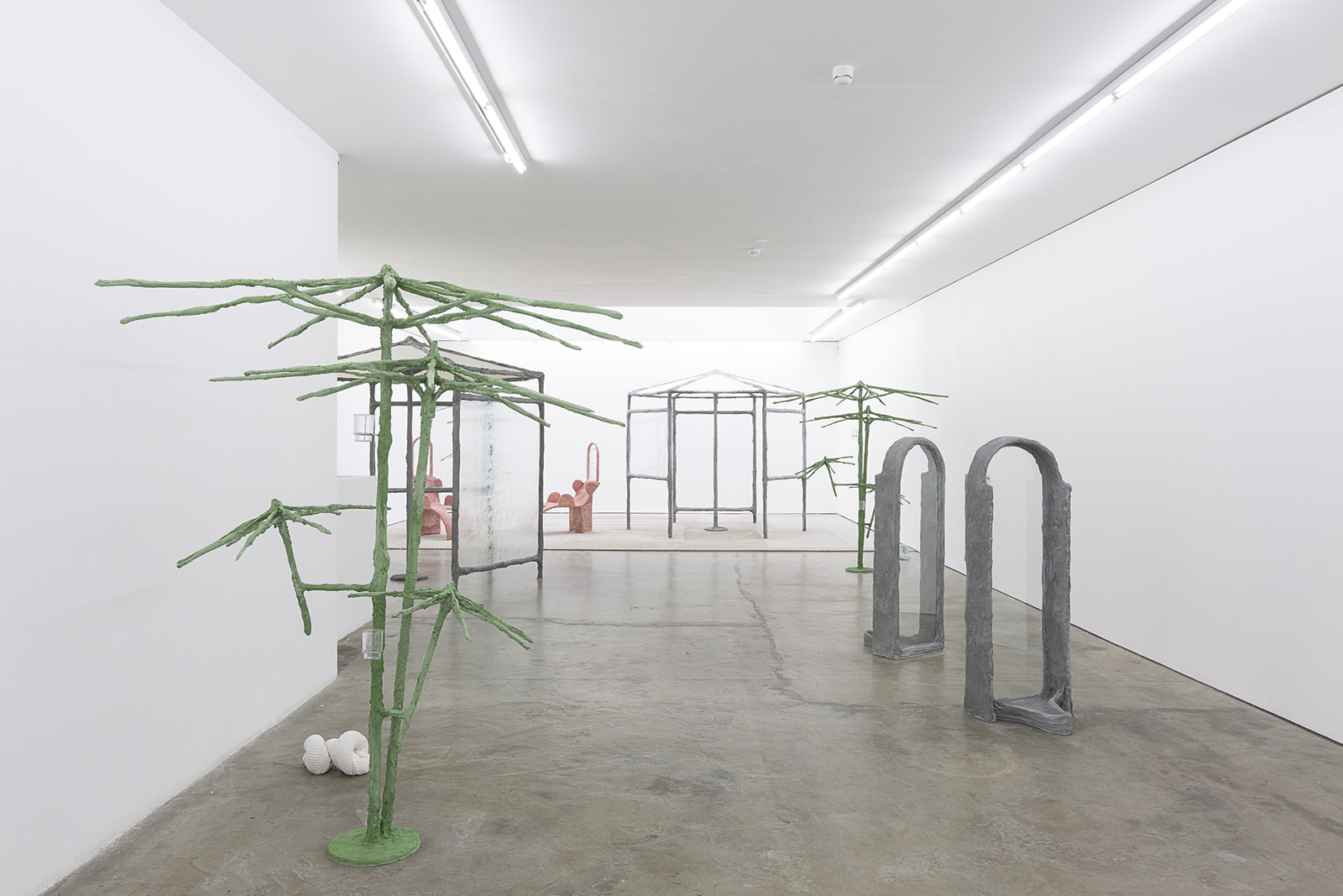 Second Nature, 2018, umbrellas, steel, plaster, burlap, sand, pigment, glass, vaseline, bath towels, cup holders