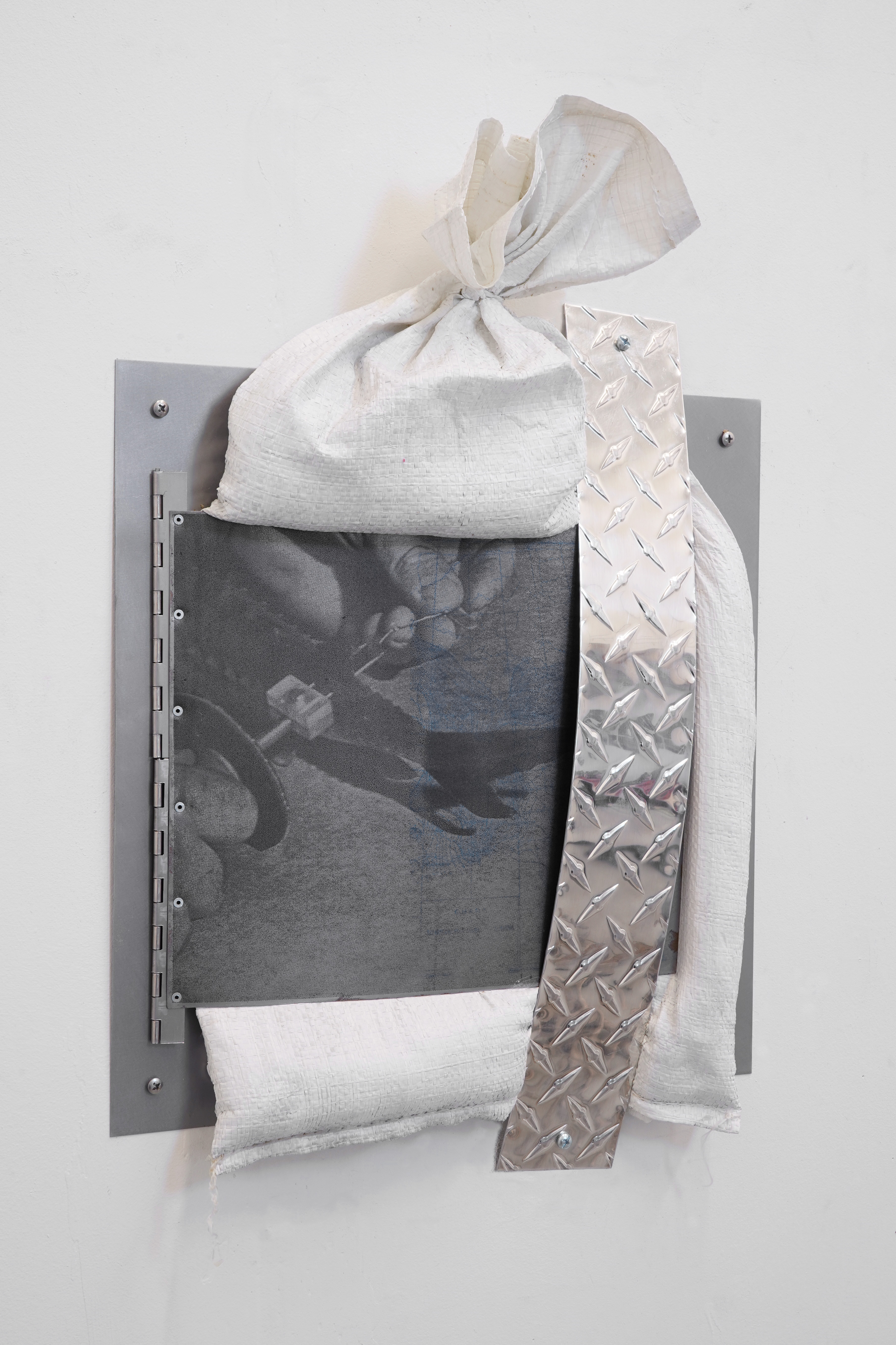 Is A River Alive?/ 2025 / Screenprint on steel, aluminum diamond plate, steel, sandbag, sand and hardware / 30 x 24 x 6 inches