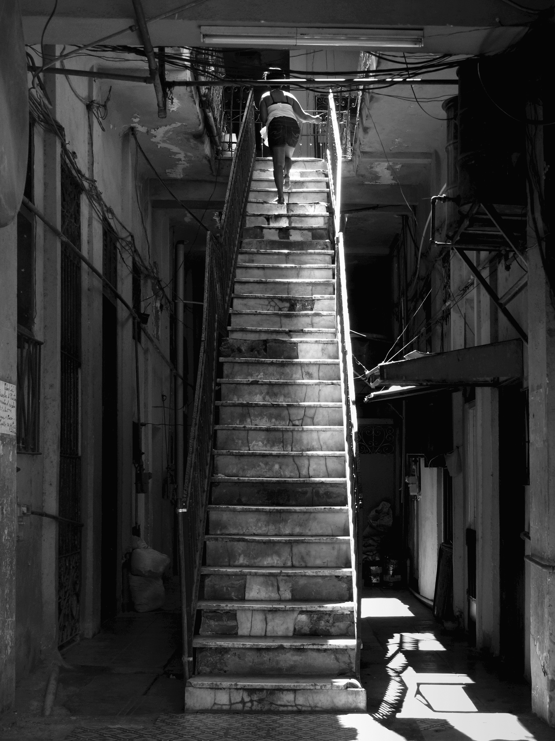 Woman ascending a staircaseLa Habana, Cuba, 2009photography, bw, single