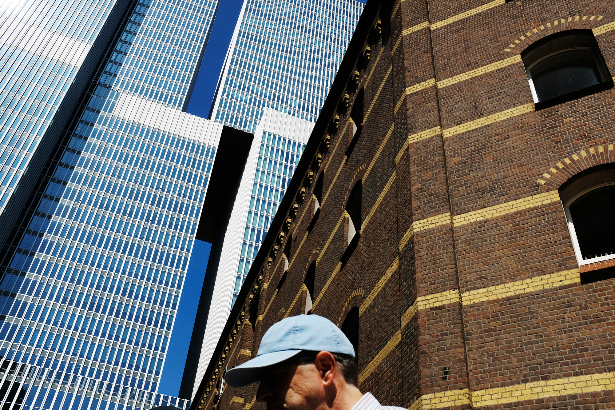 Philippe Sarfati-architecture photography-photographer-photography-street-documentary-architecture-oma-de rotterdam-rotterdam-netherlands-tower-blue-cap-man-traditional-modernity-dutch-brick-brown-geometry