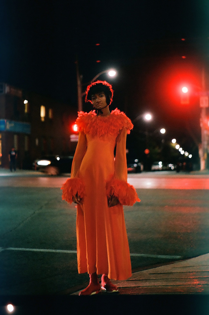 Toronto fashion model standing on street at night