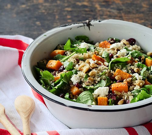 Delicious looking acorn squash and cranberry salad in a bowl.