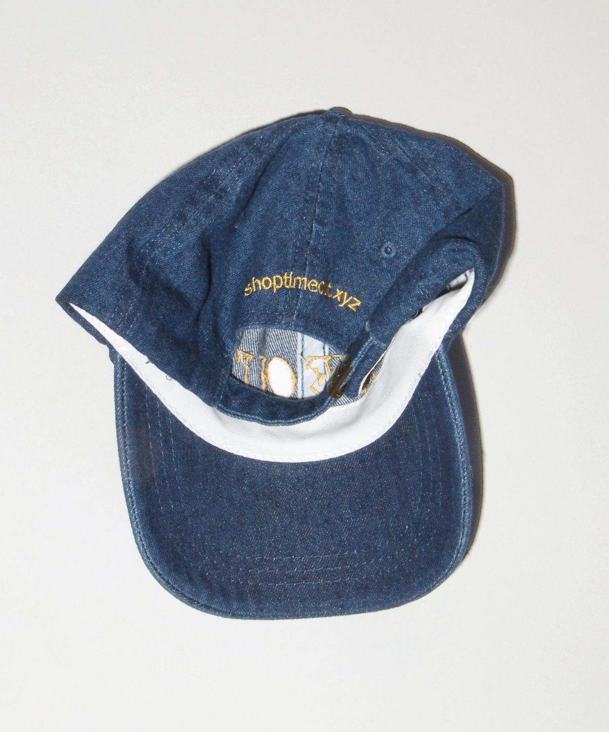 Washed denim cap with web address on back