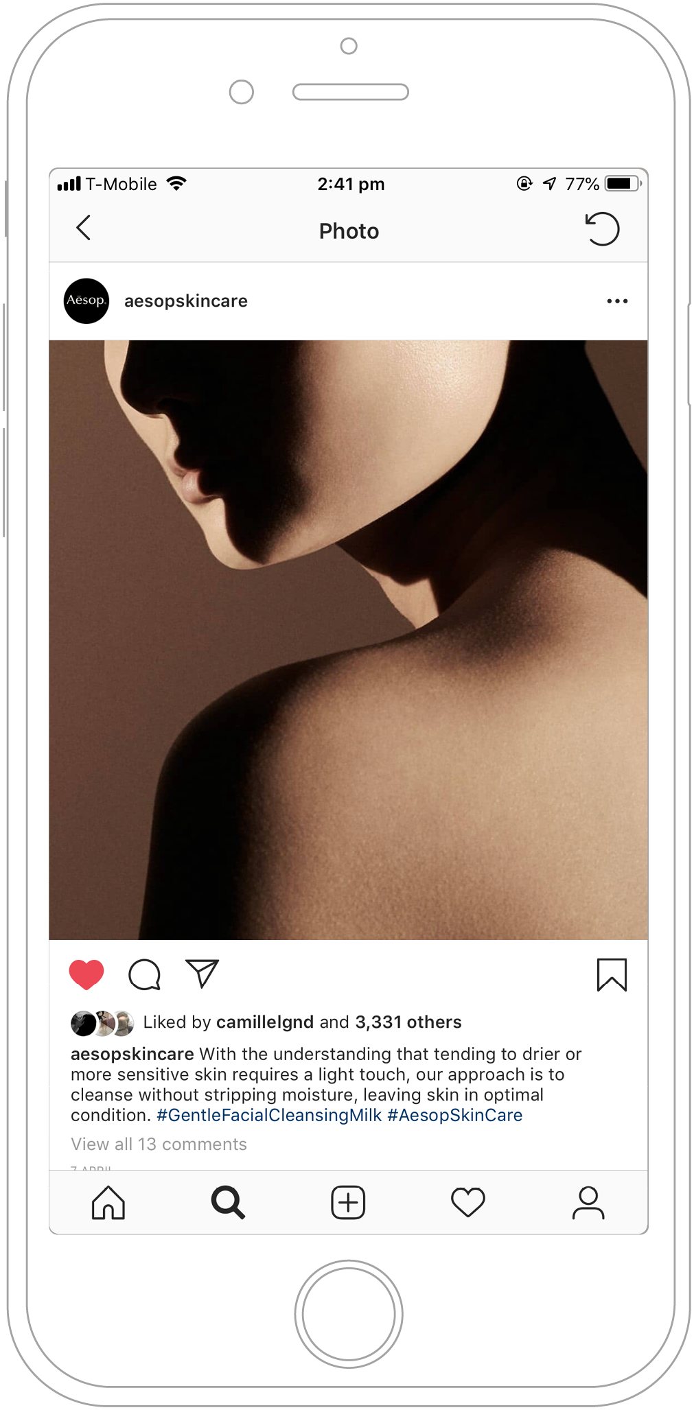 A phone screen showing an instagram post of a tightly cropped face, neck & shoulder bathed in soft light.