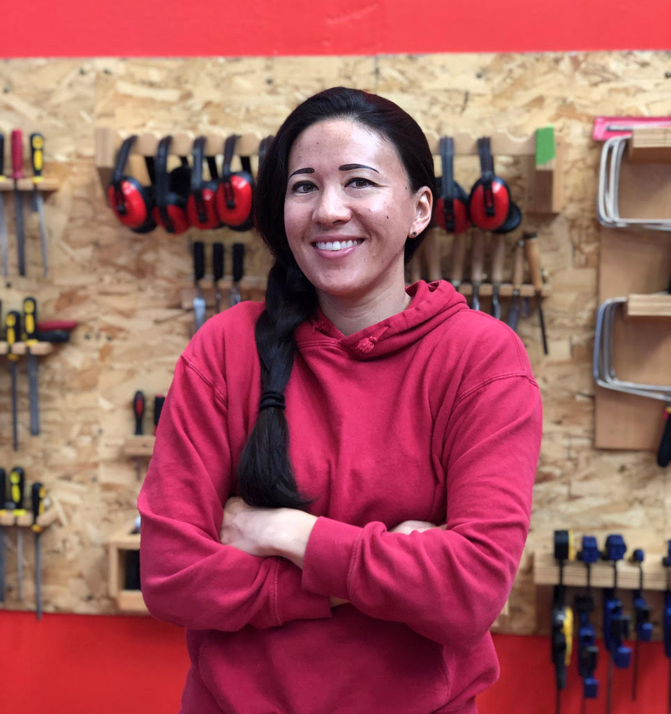 Emily at Girls Garage, in front of the workshop’s tool wall.