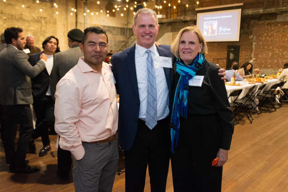 Chrisanto Hernandez Garcia, Board Member Tim Gilson, Global Detroit's Kate Brennan pose at Tapestry 2022.