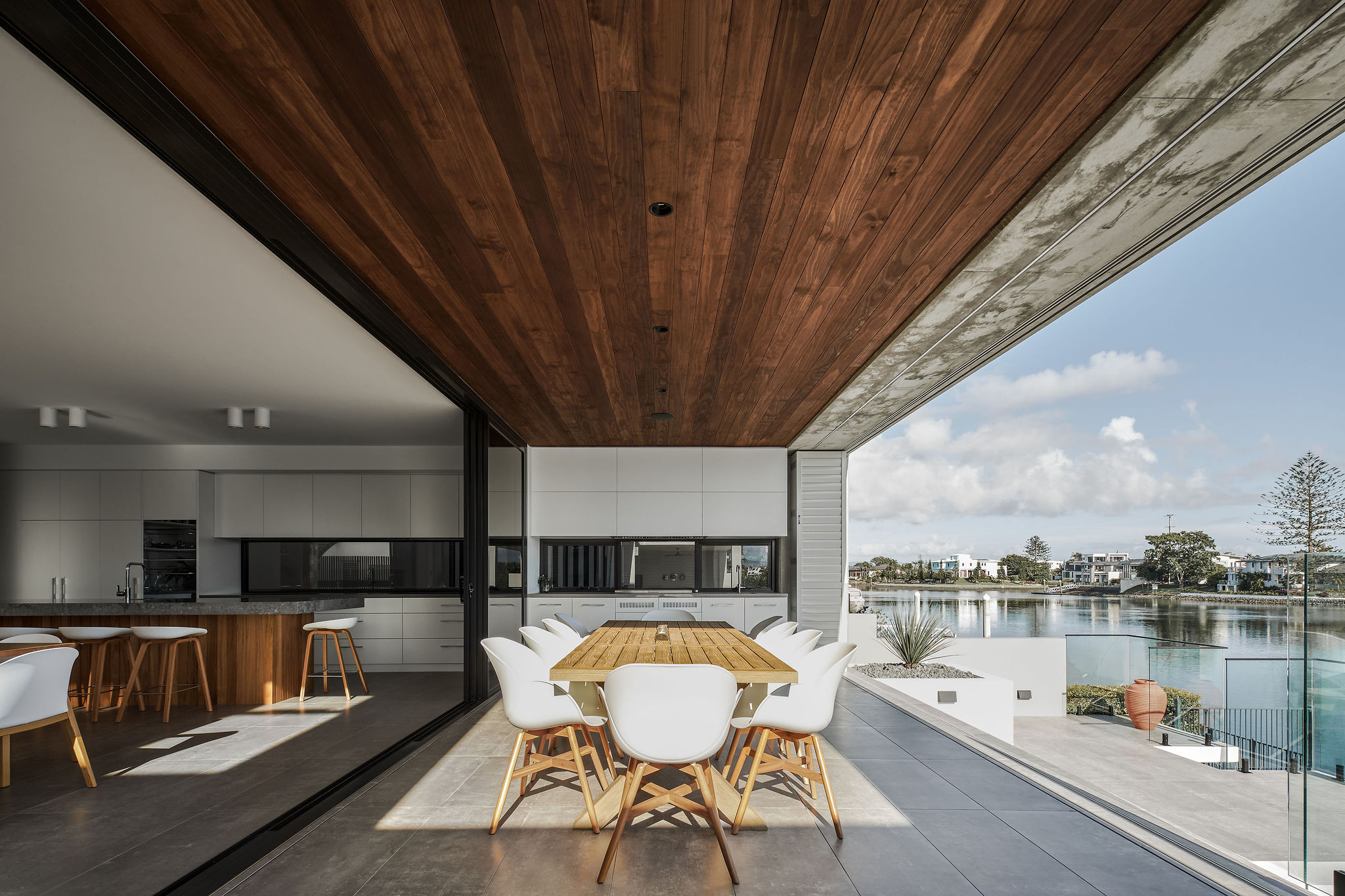 Contemporary home patio overlooking waterway, outdoor dining, Broadbeach Waters, Gold Coast, Queensland