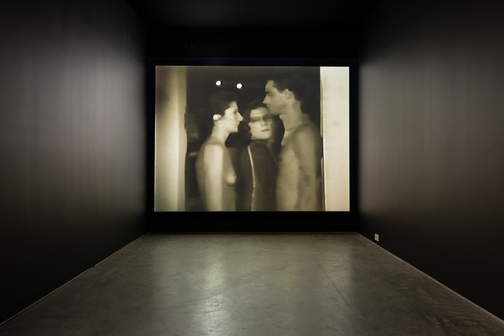 Installation view of Marina Abramović & Ulay's "Imponderabilia", 1977, Single channel video projection, black and white, loop, sound. Image by Etienne Frossard.
