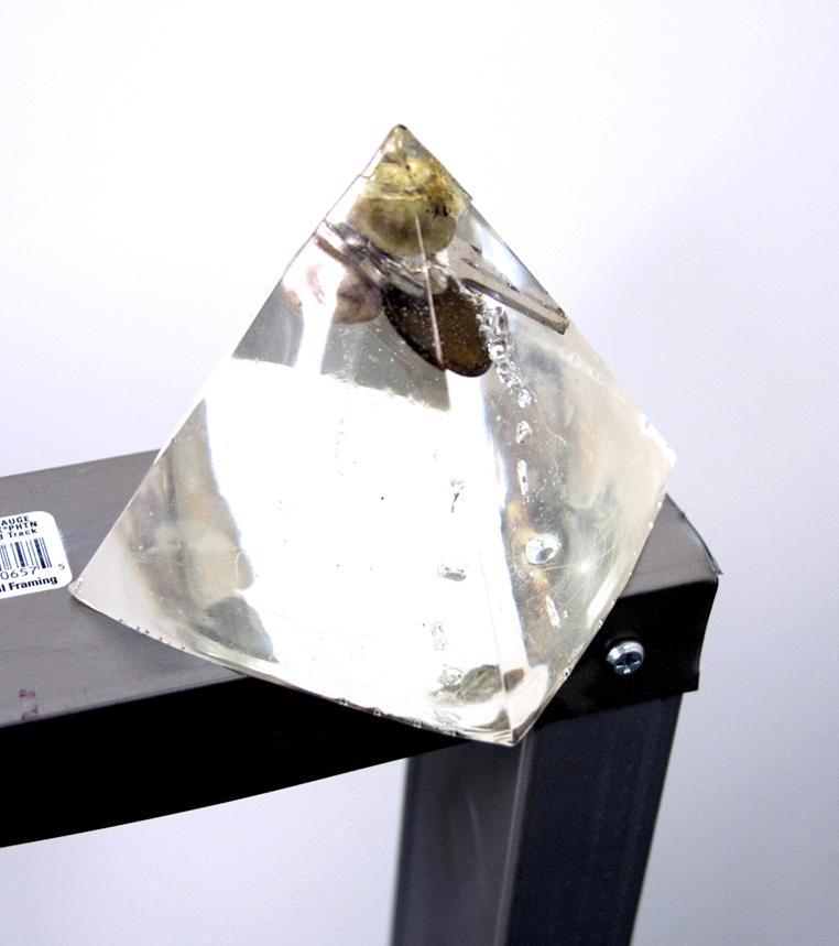 Detail of The Dreamer's Corner, 2018, 35"x32"x32". Steel, television, media player, single channel video (looped), acorn, key, pebble, penny, epoxy resin