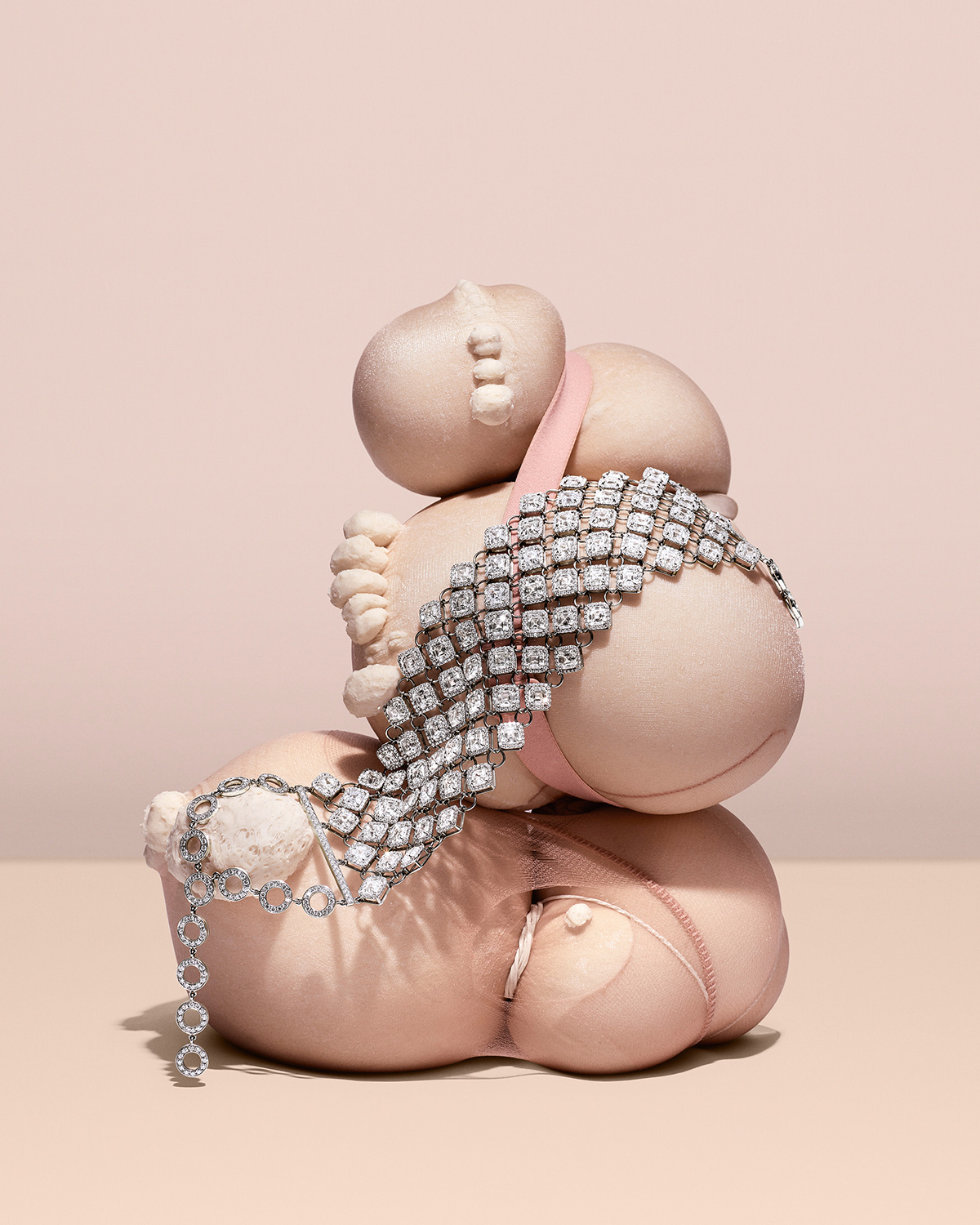KMA photographer Isabelle Bonjean shoots photograph of diamond bracelets against a nude pink background 