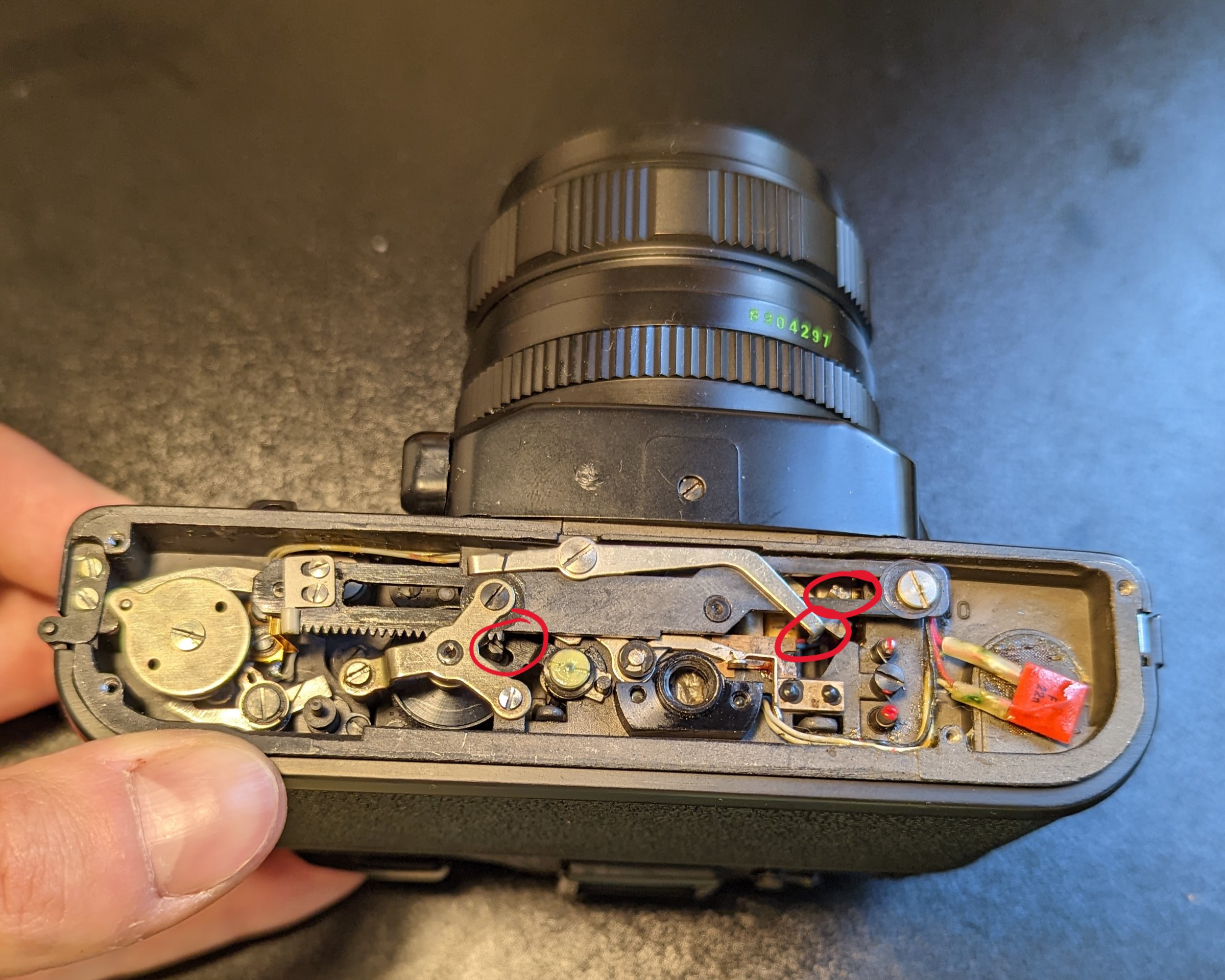4. Shutter button pressed and held in bulb mode (manual shutter speed setting). The pin on the left has rotated back into the appendage. This is likely to be the mechanism responsible for the curtain that allows light to reach the film.