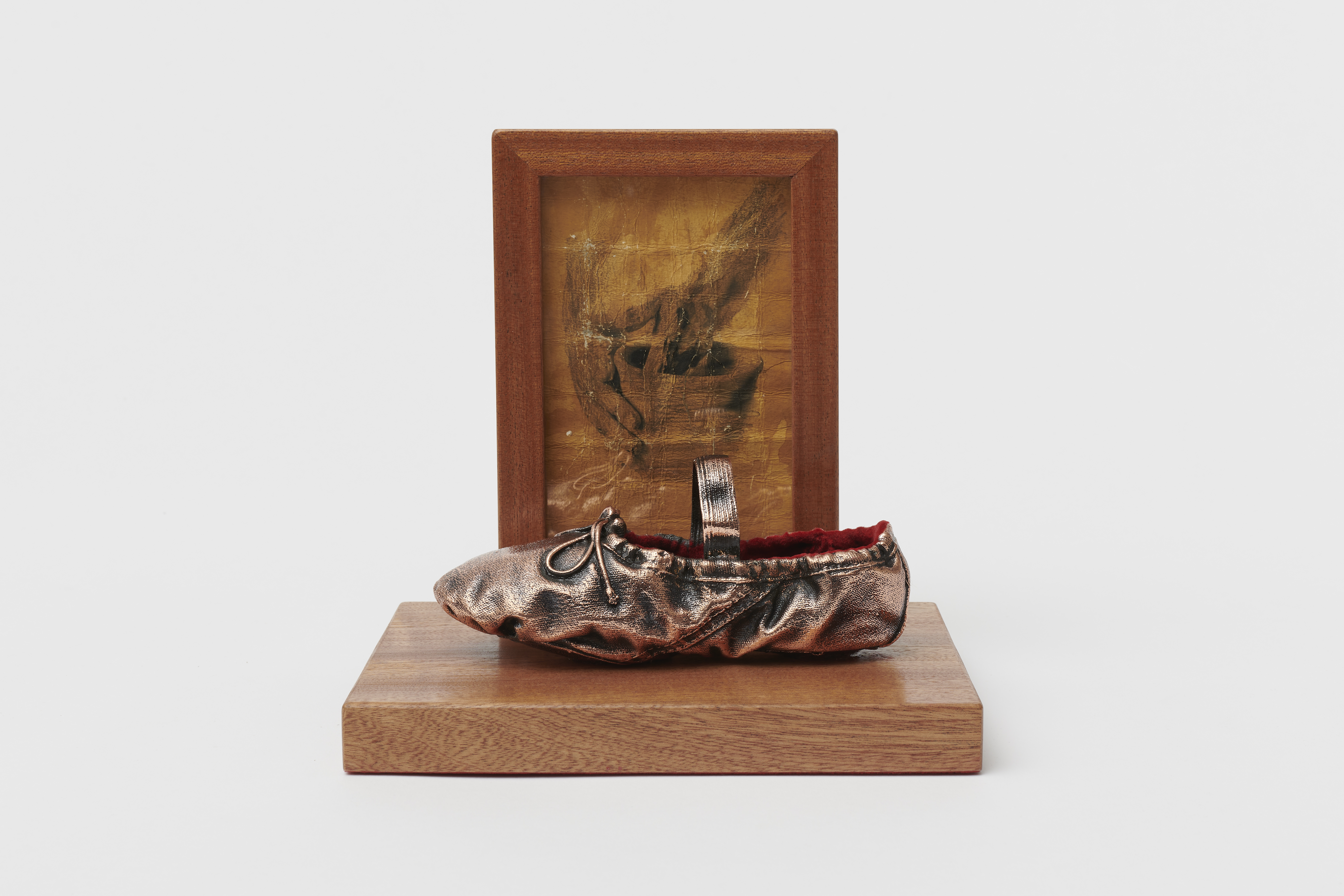 Liberal Trauma Trophy #2, 2023 custom bronze cast, found frames, velvet, bronze imitation paint, mahogany imitation paint, giclée print German etching dyed in instant coffee 19 x 20 x 14 cm