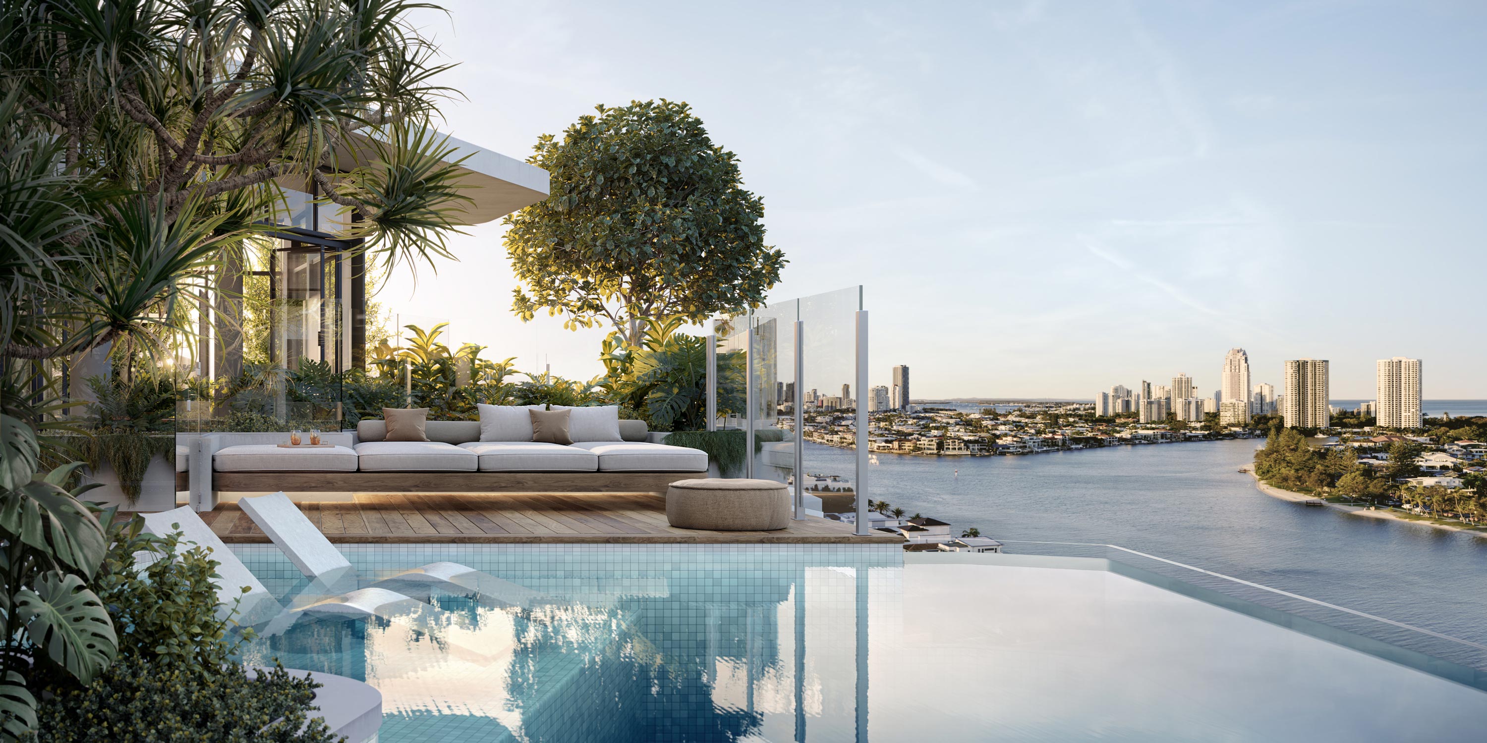 A serene pool with a stunning view of the water and city skyline.