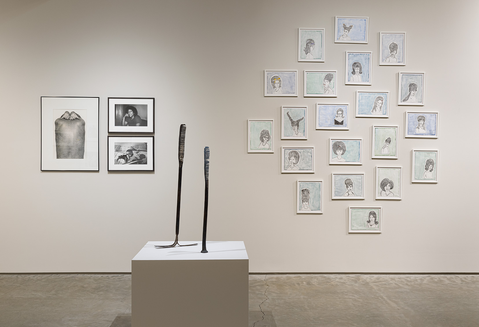 (left) John Coplans, Back and Hands, 1984. Gelatin silver print, 20.5 x 13.75 inches; Joseph Rodriguez, Self Portrait, 1971. Chromogenic print, 9.5 x 13.5 inches; Joseph Rodriguez, Javier in his uncle’s car, 1993. Chromogenic print, 9.5 x 13.5 inches. (middle) Jarret Key, Hot Comb 3 "Snaggle Tooth", 2020. Black forged steel with bronze burnishing, 29.5 x 2.5 x 2 inches; Hot Comb 4, 2020. Black forged steel with bronze burnishing, 36.5 x 2.5 x 13 inches.(right) Melissa Stern, High School Hair, 2020. 20 graphite, watercolor, and colored pencil drawings, 9 x 12 inches each. Photo by Etienne Frossard.