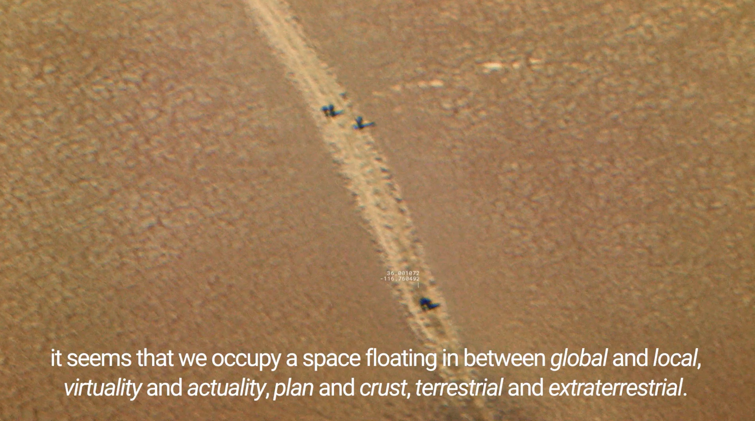 A dessert with a path through the center. Text at the bottom of the image reads "It seems that we occupy a space floating in between global and local, virtuality and actuality, plan and crust, terrestrial and extraterrestrial.