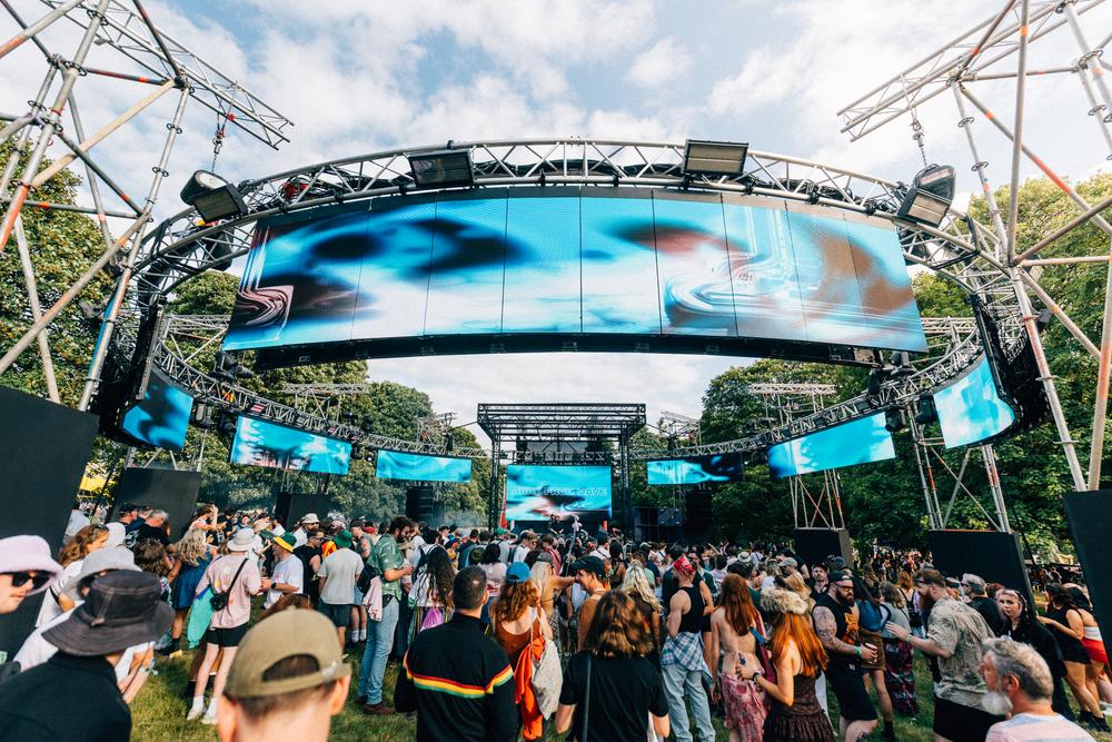 Festival crowd gathered at IMMERSE stage during daytime with LED visuals