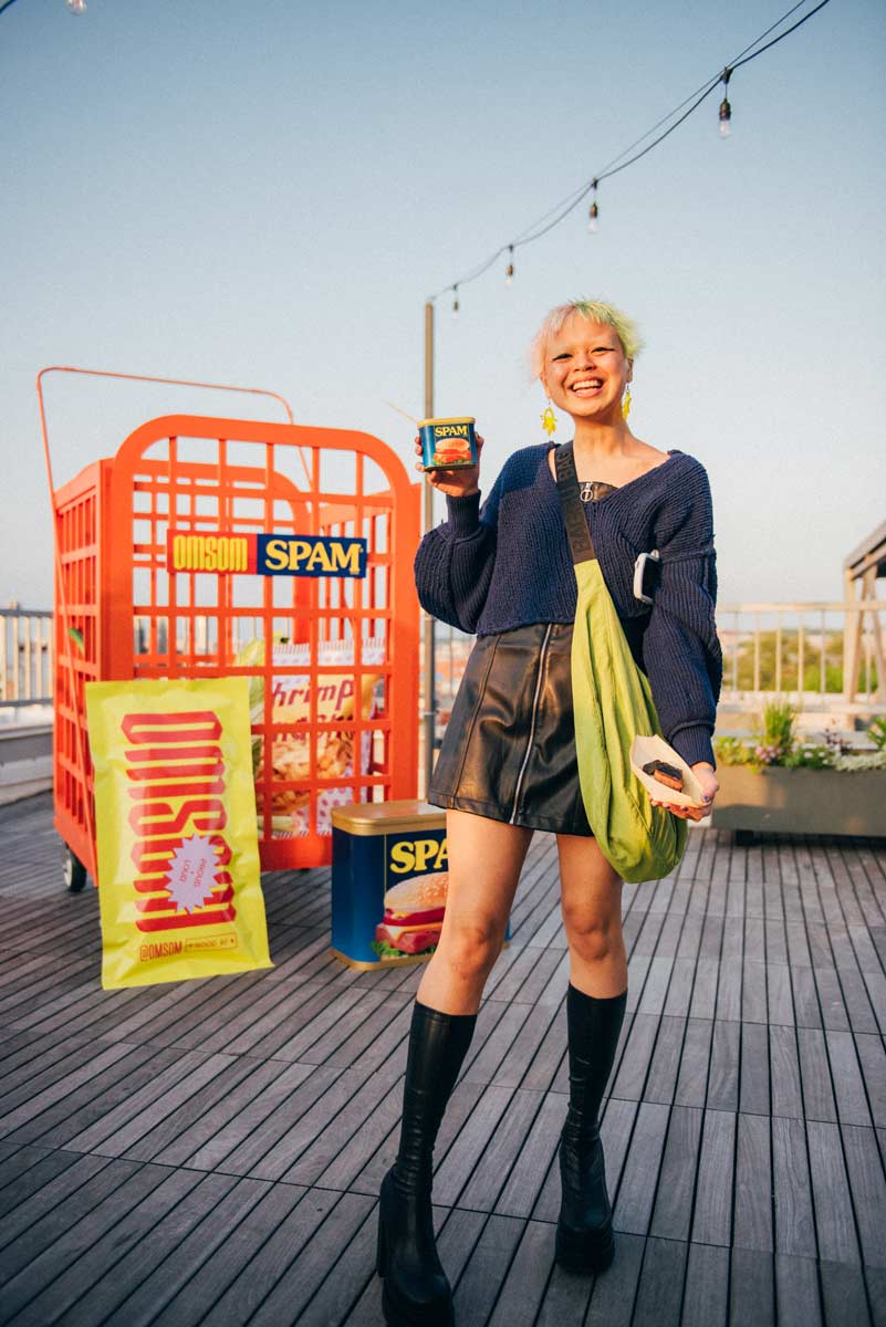 Person posing with their drink made in SPAM packaging