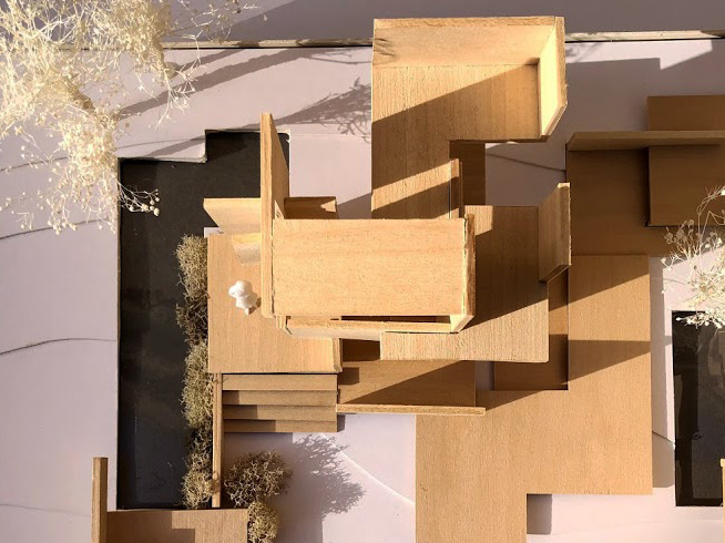 a photo of a wooden model, that from the top view, looks like a dramatic puzzle.