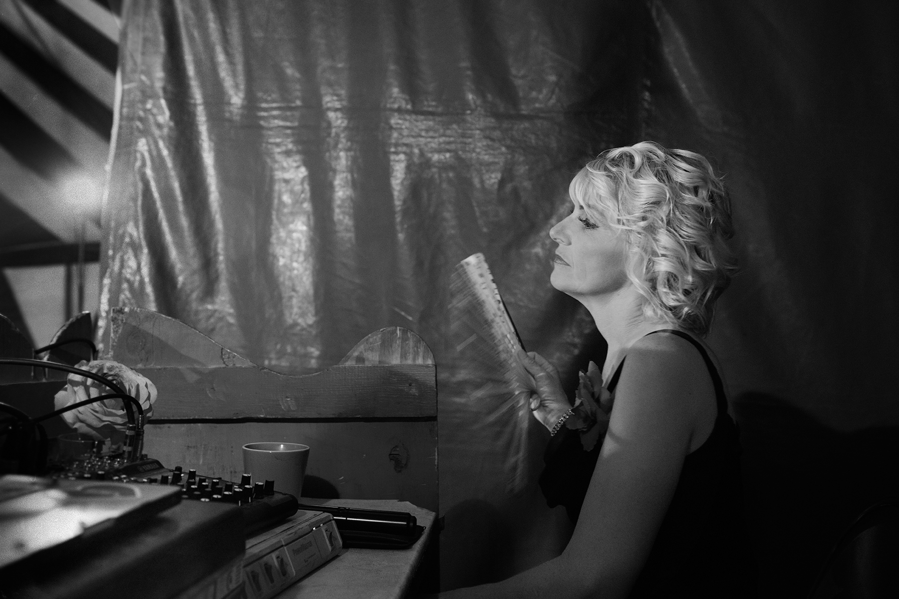 Miss Natalie, the ringmaster, watches the performance behind the stage. She also presents her dogs as part of the show.