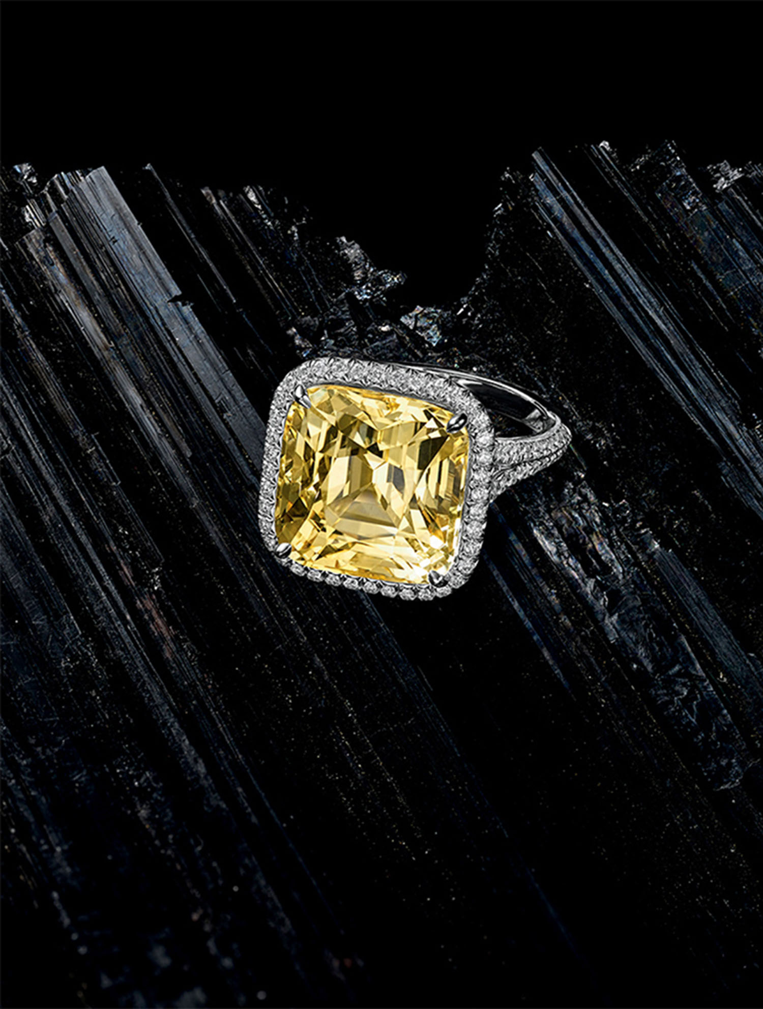KMA stylist Sara Wacksman designs set for a photo of a diamond ring with a yellow gemstone laying on a piece of charcoal