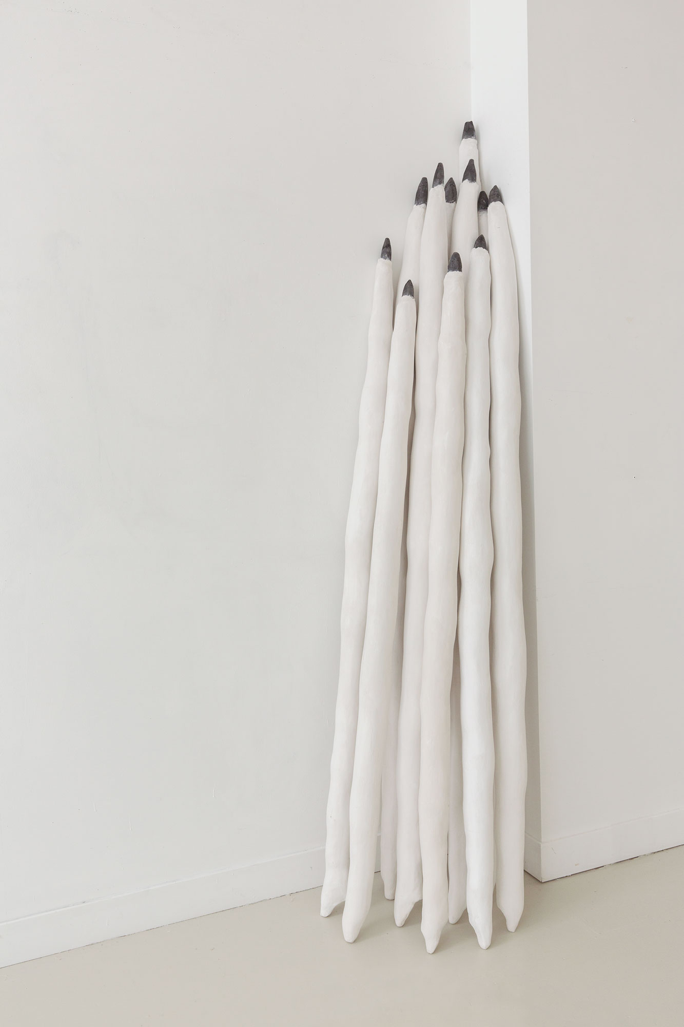 Mômopens, 2018 Plaster, graphite 11 objects Each between 188-220 cm x 8-10 cm Ø