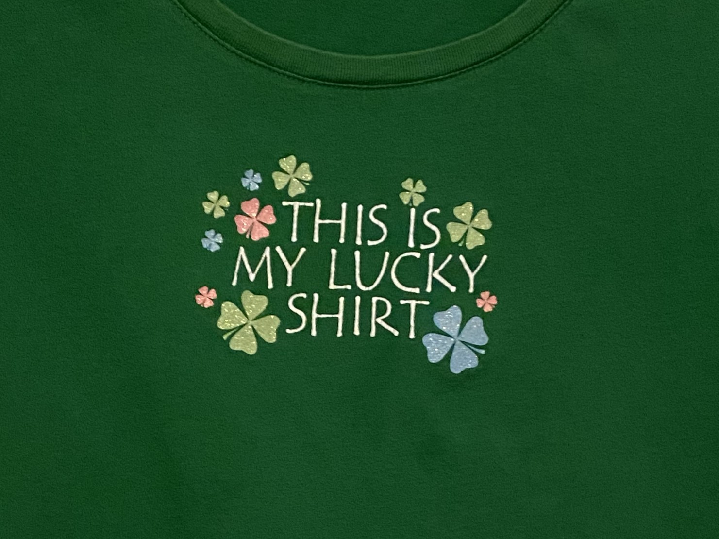 Hidden nod to the production team, The Lucky Clover Team, on Zoe's shirt.