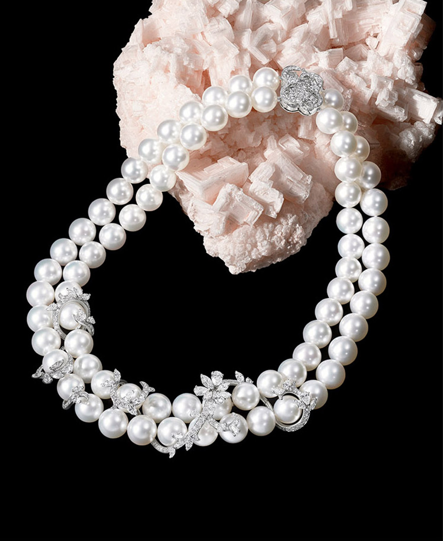 KMA stylist Sara Wacksman designs set for a photo of a diamond and pearl necklace and pink rock on a black background