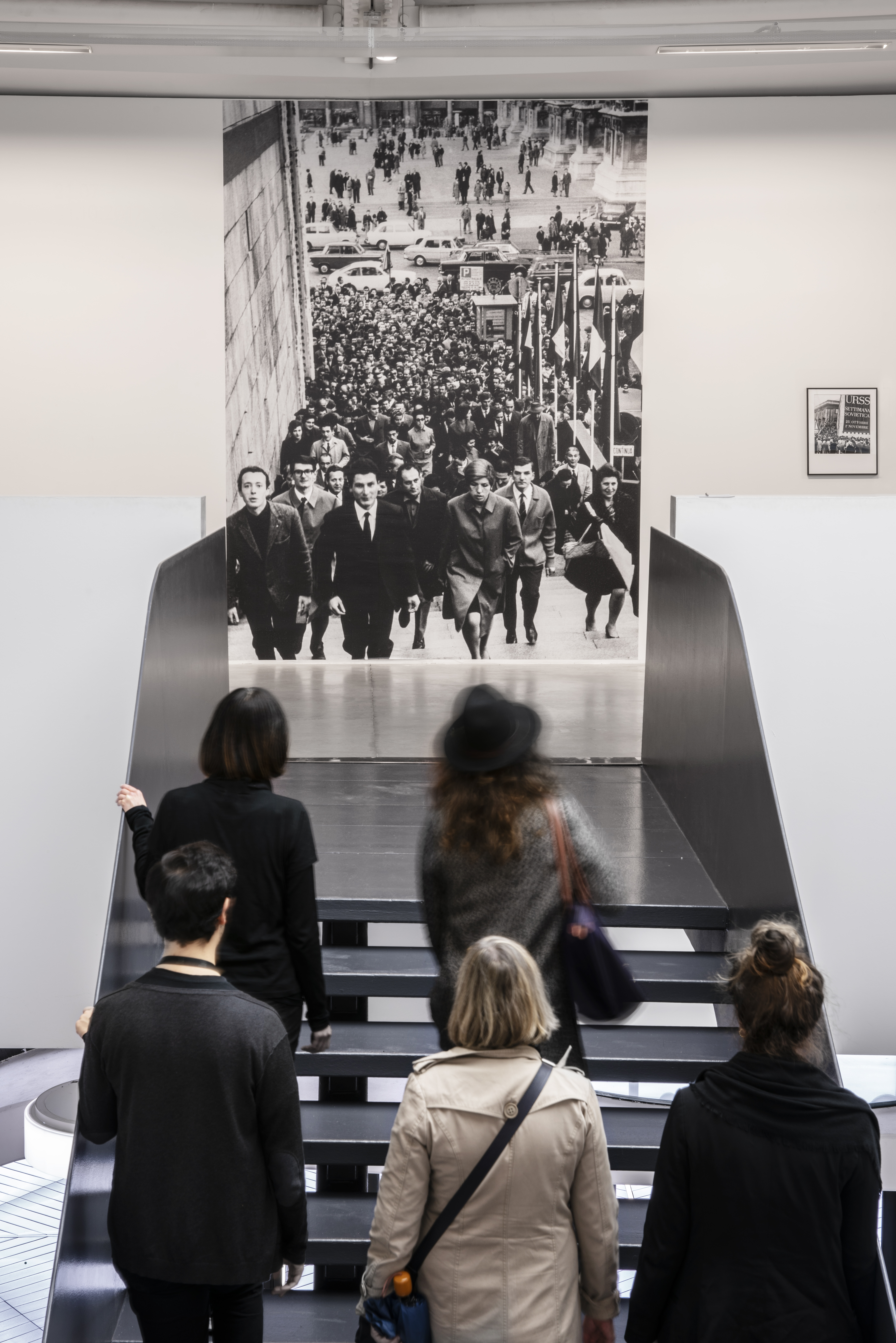 Opening of Soviet Week Exhibition at the Palazzo Reale, Milan, 1967, 2017. Wall-size black-and-white digital print and framed archival pigment print (50×40 cm). Installation view at Centro per l'Arte Contemporanea Luigi Pecci, Prato, 2019. Photo courtesy: Associazione Italia Russia Lombardia, archivio fotografico. Courtesy: the artist.  Photo: Ela Bialkowska