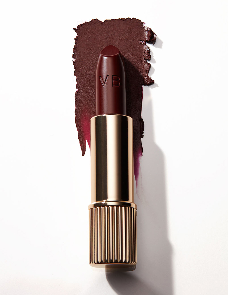 KMA stylist Rachel Haas designs set for photograph of smeared brown lipstick on white background for Victoria Beckham