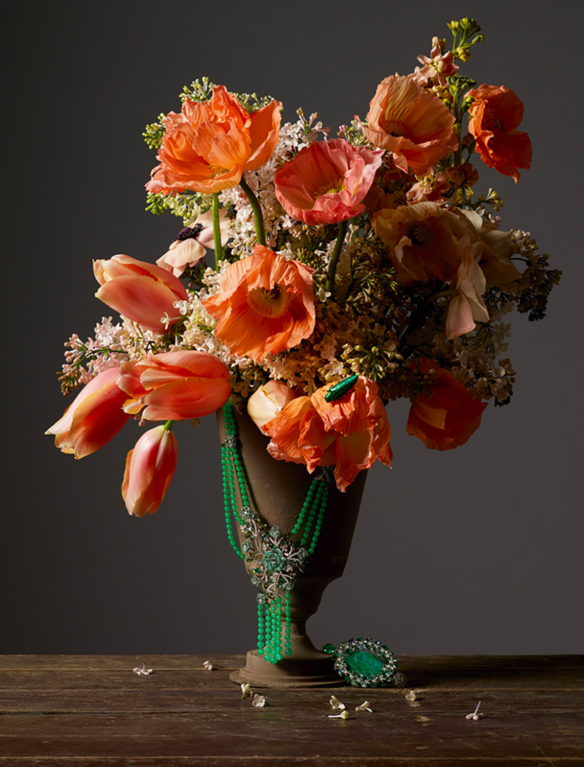 KMA photographer Isabelle Bonjean shoots photograph of orange flowers and green jewelry against grey background for Citizen K