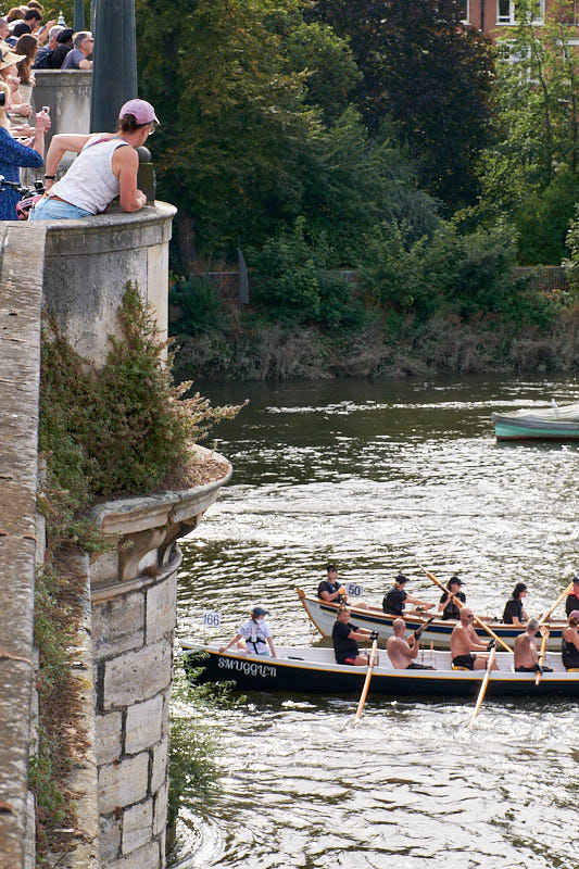 ...with crowds watching the approaching rowers on the opposite side.