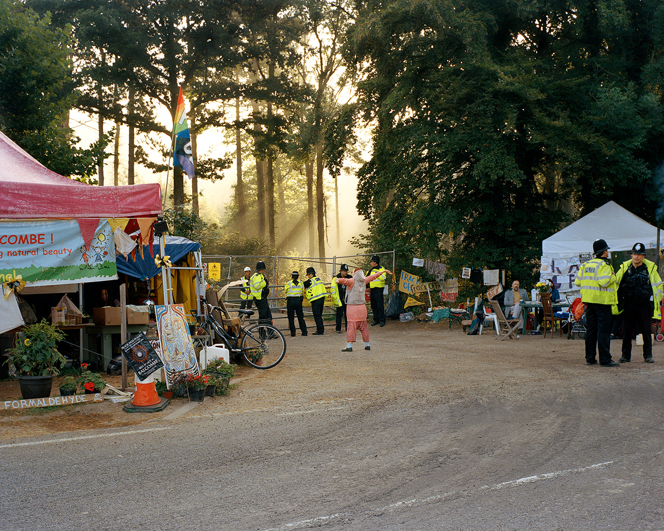Balcombe, United Kingdom. An anti-fracking protester in front of the gate of the Balcombe drilling site, West Sussex. From the 25th of July 2013, part of the population of Balcombe and activists from all over Britain gathered against unconventional gas explorations. They initially occupied the land on which the rig was supposed to be erected and then the road that leads towards Brighton. The so-called Great Gas Gala lasted 68 days: it did not prevent Cuadrilla from drilling, but it was a first and important moment of self-awareness for the British anti-fracking movement