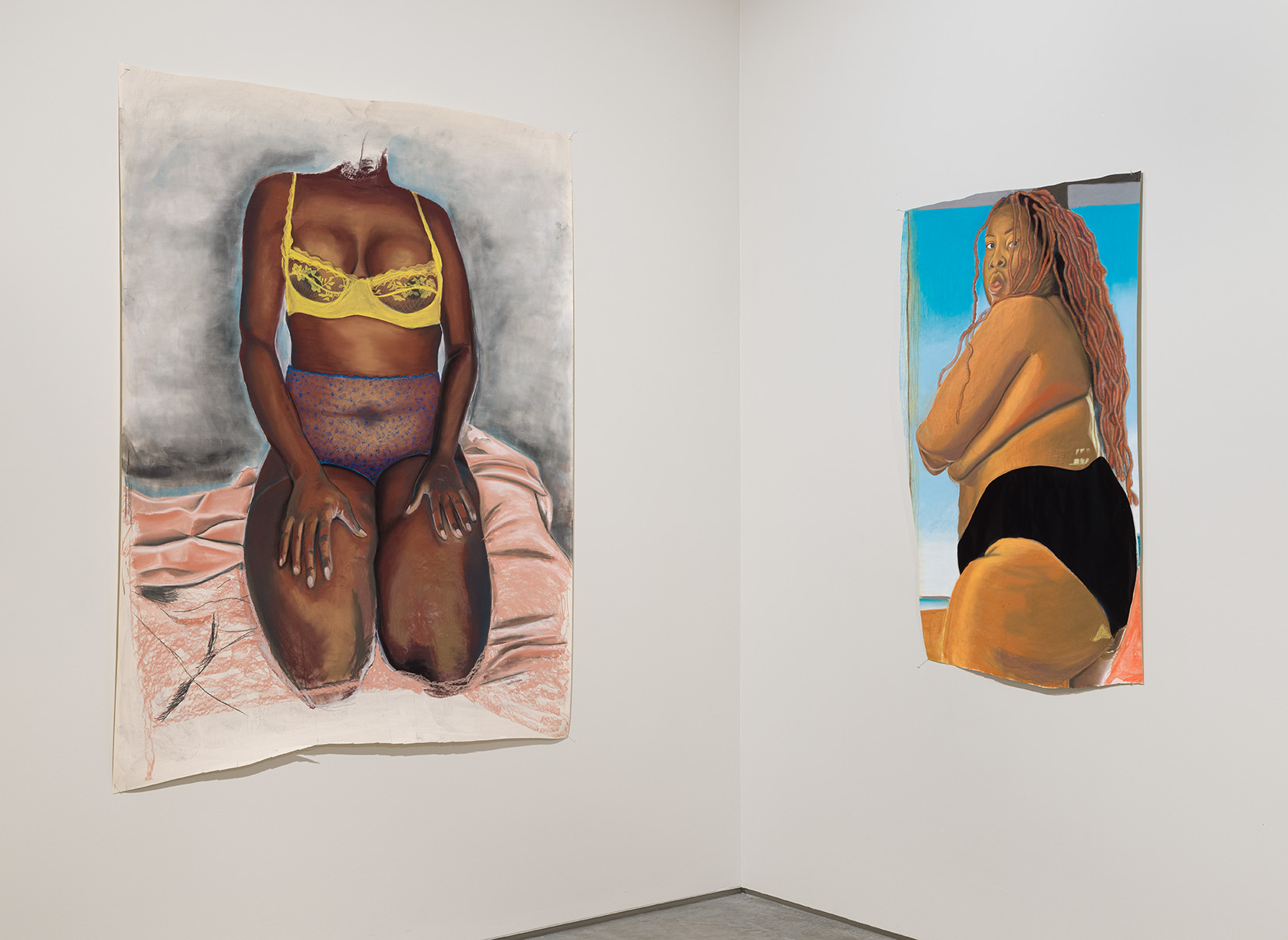 Left: Rebecca Jean-Phillippe, "Kneel", 2022, Pastel on paper, 73 x 55.5 inches. Right: Rebecca Jean-Phillippe, "Look Back At It", 2022, Pastel and wallpaper on paper, 54.5 x 34 inches. Image by Etienne Frossard.