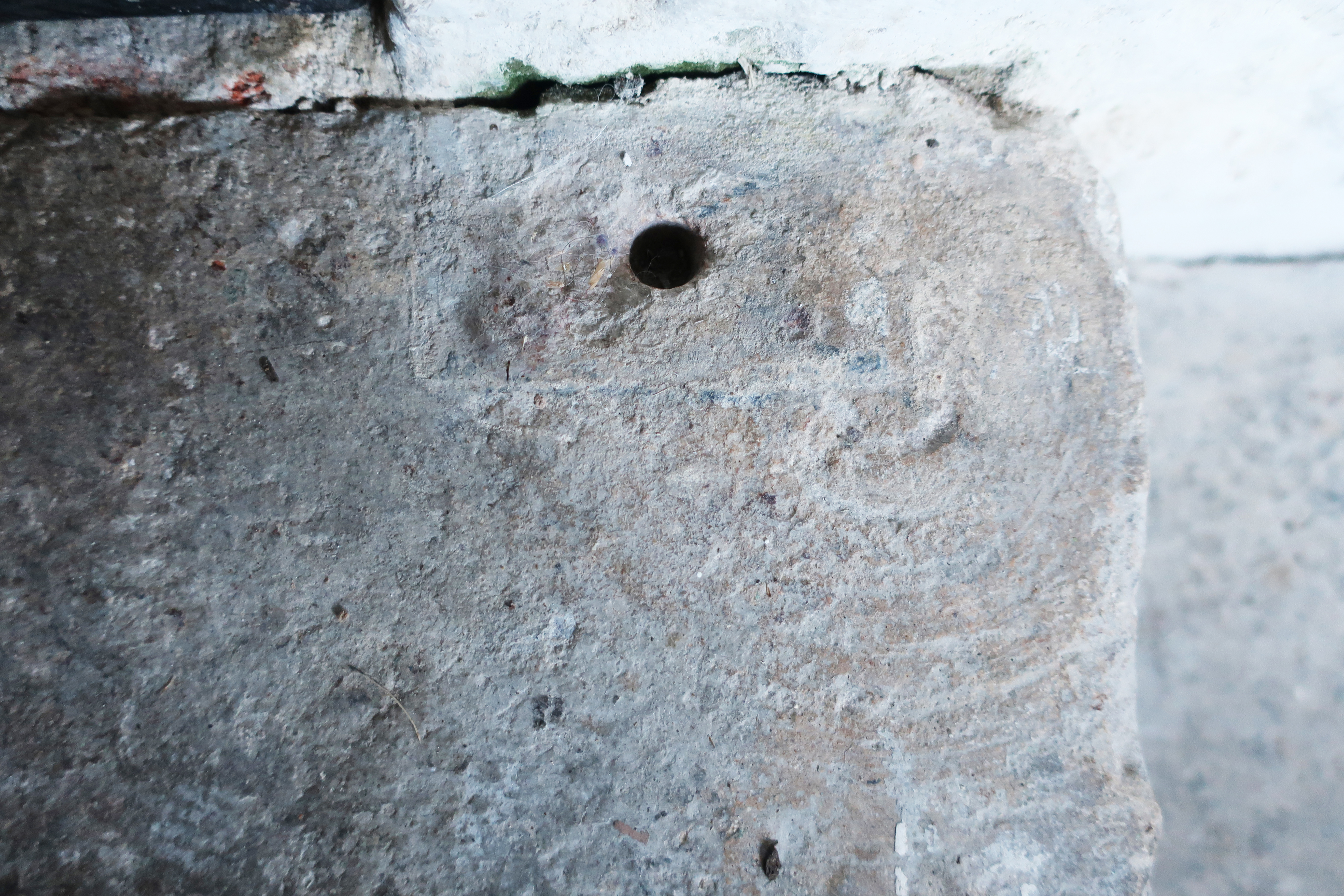 Traces of where a heavy door created ripples in the stone threshold, Rebecca Disney.