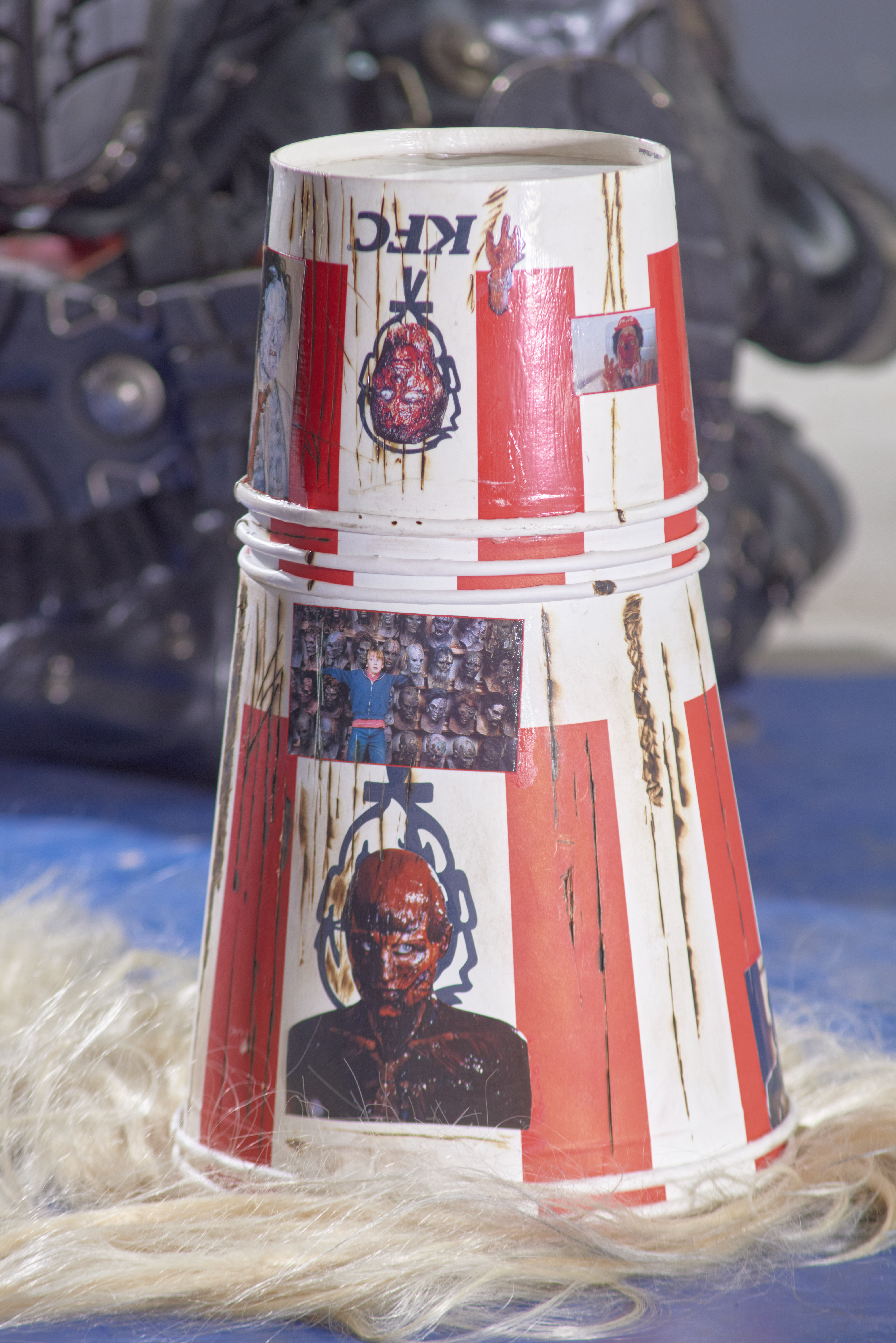 Buckethead, 2021 (detail). KFC buckets, blond hair, horror images. Variable sizes.