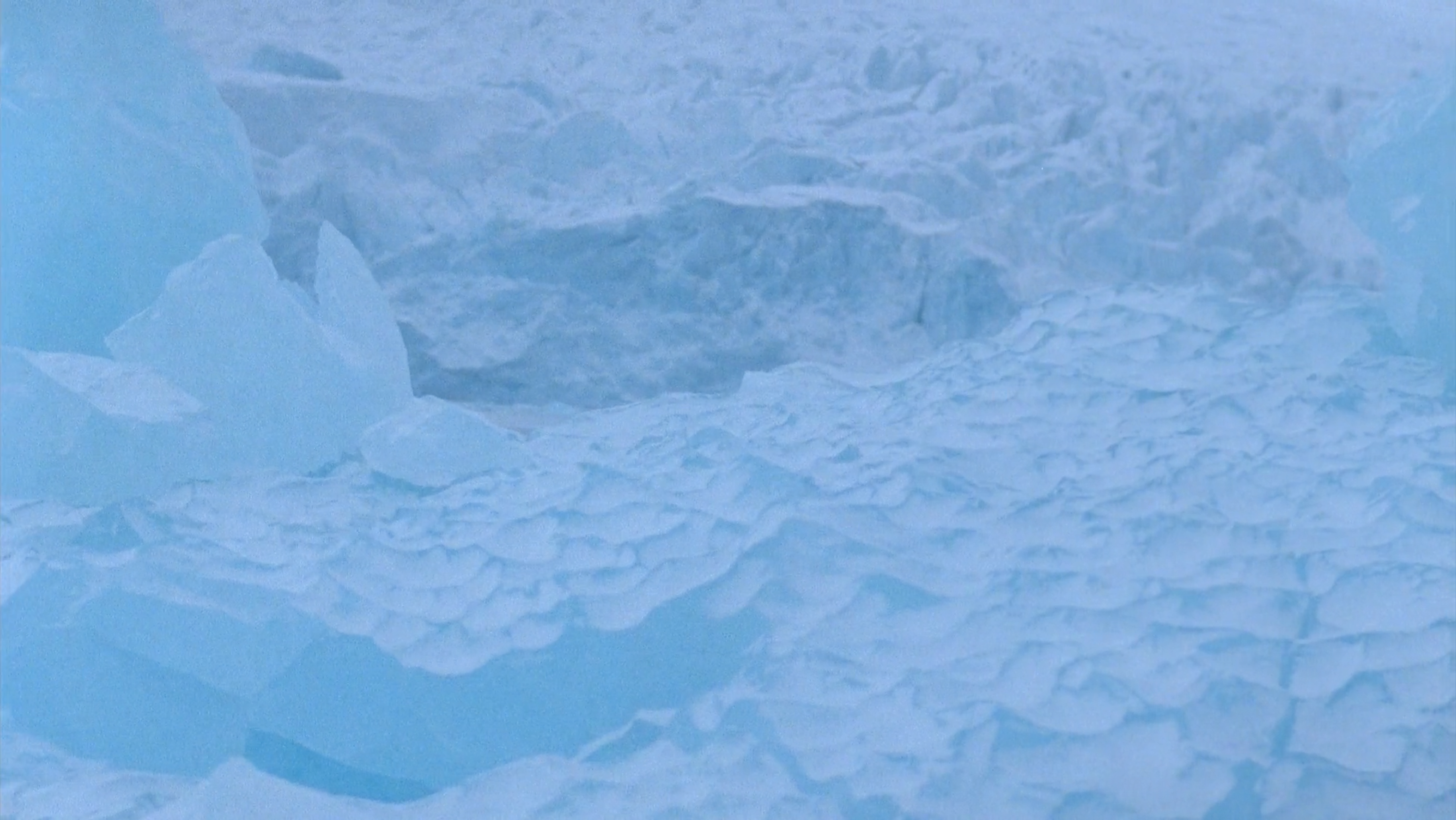 Never Happened Again, Glaciers 2, 2012. Single channel video captured with an Aaton Minima 16mm film camera at Monacobreen, Svalbard Archipelago in the High Arctic. Duration: 8 minutes, 48 seconds. Still frame.