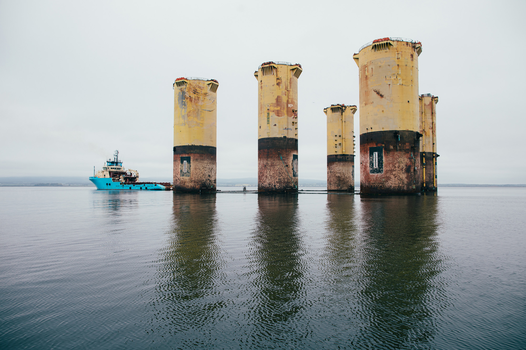 The giant Hutton tension leg platform is being moved to the Queen's Dock at Invergordon. The process of lifting the 500 tonnes of chains and anchors and towing the platform five miles to Invergordon took 36 hours and involved six tugs accompanied by a rescue boat